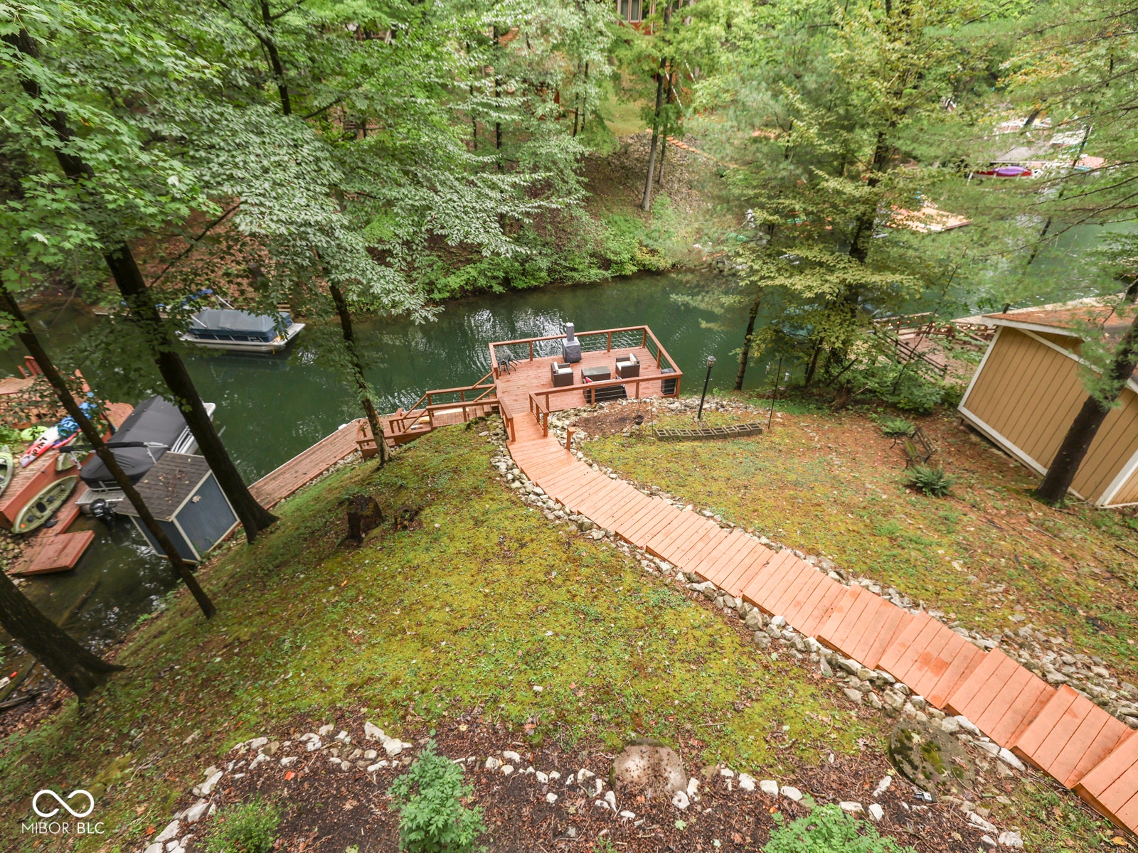 Waterfront property with a wooden dock, private boat slip, and direct water access
