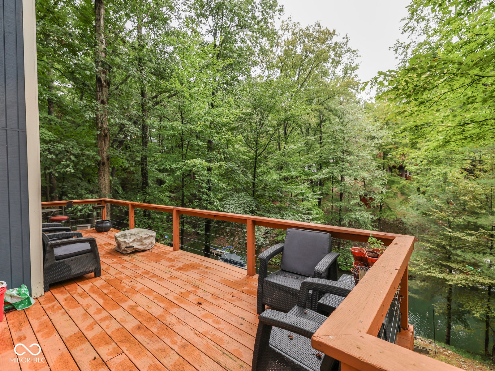 Wood-finish deck with a wood-tone railing and cable infill