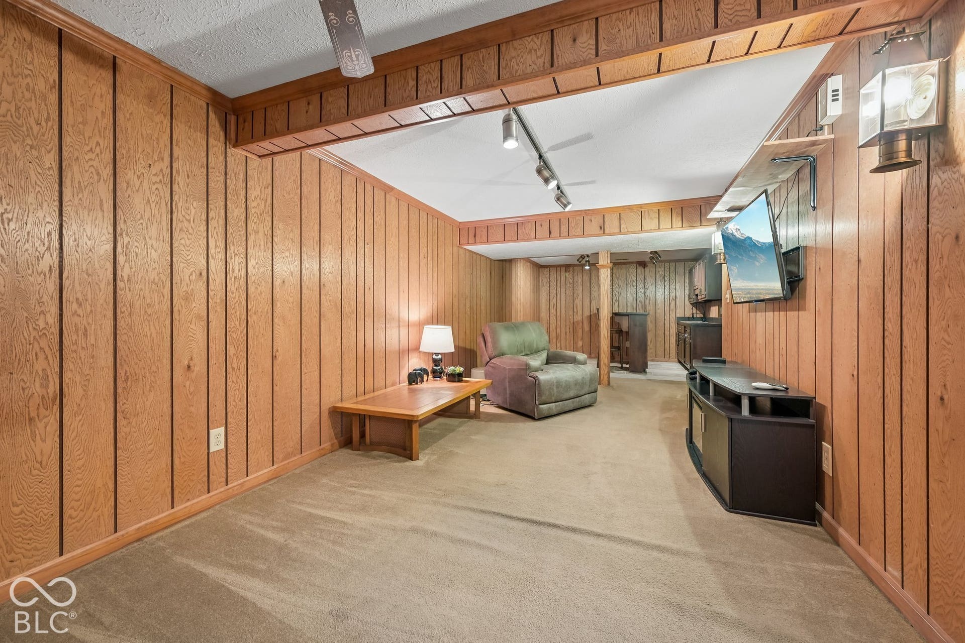 Wood-paneled walls with coordinating wood trim and ceiling beams