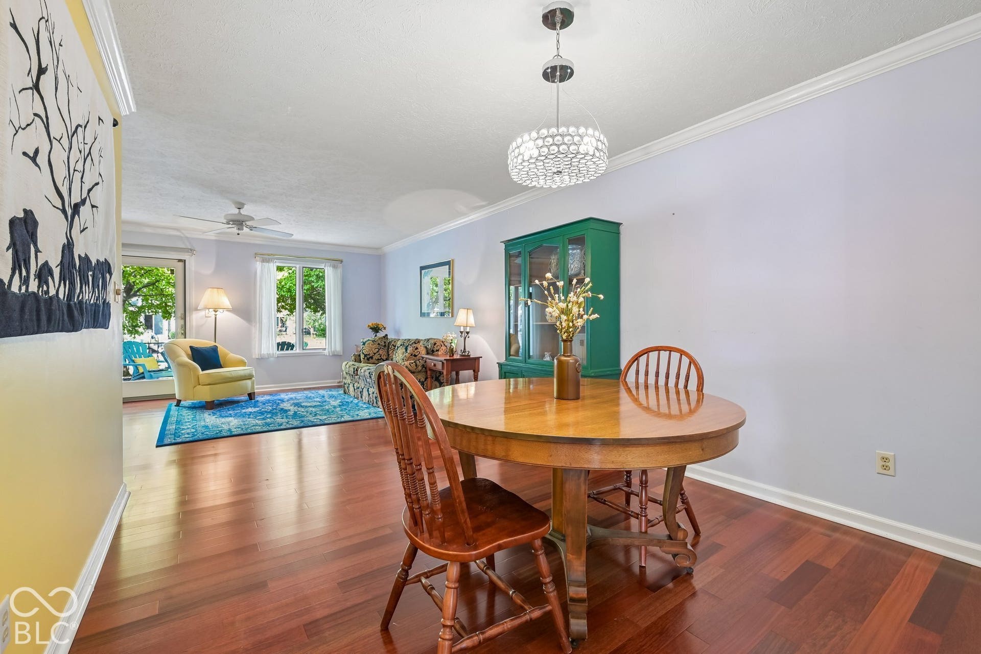 Hardwood flooring, crown molding, double-pane window, ceiling fan, and a contemporary chandelier