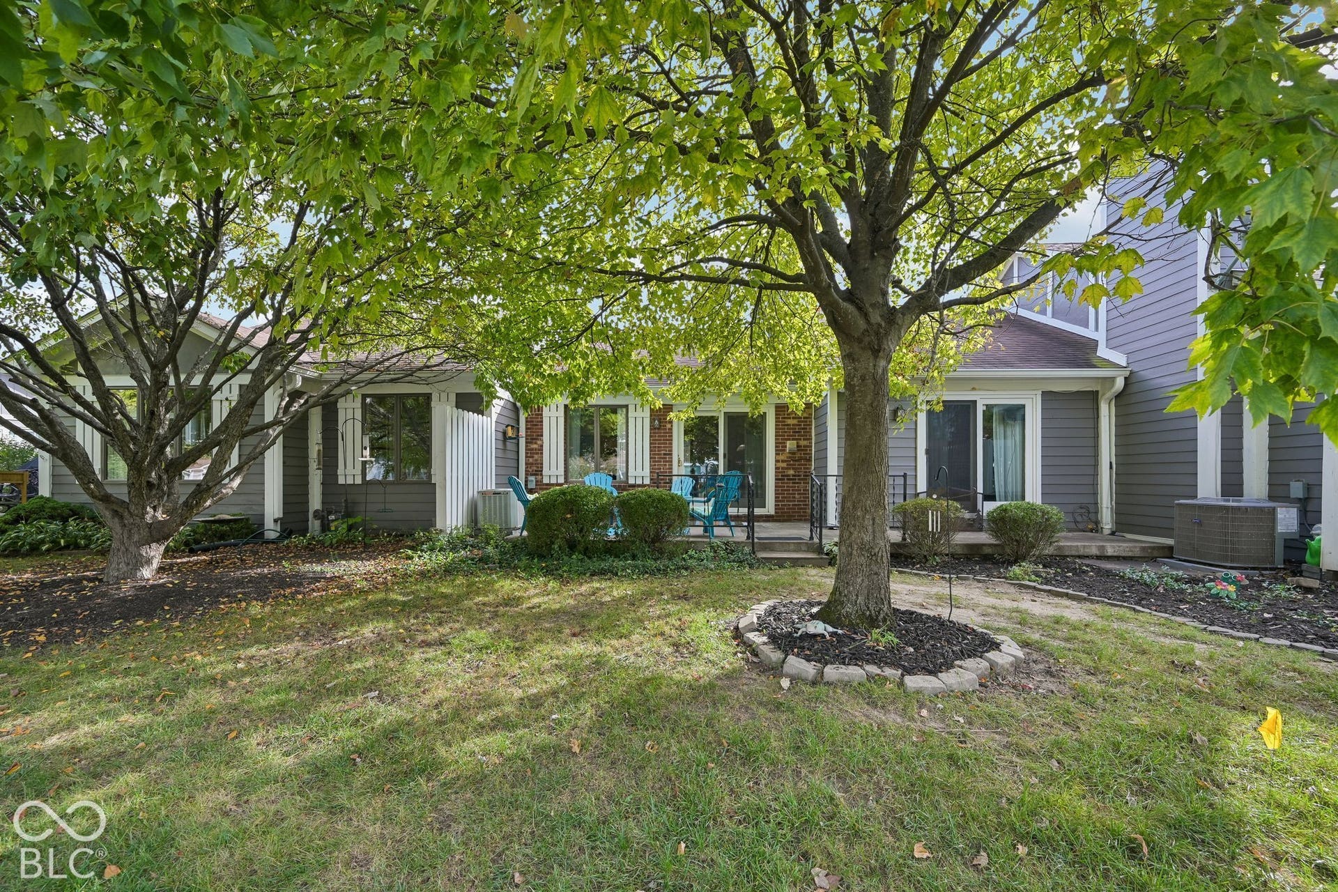 Manicured green lawn with mature trees, offering a private outdoor area