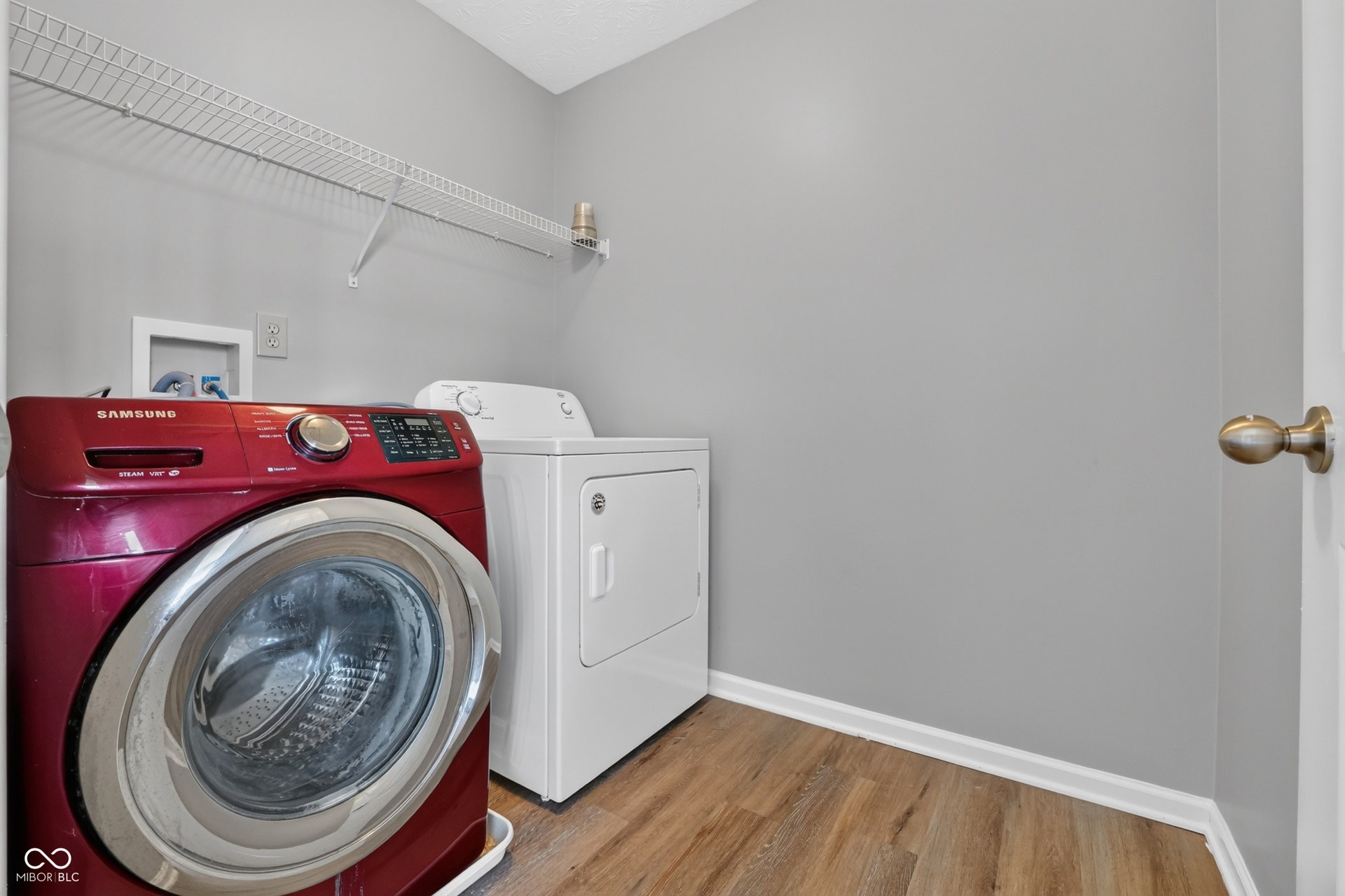 Wood-finish flooring, light gray wall paint, and white trim