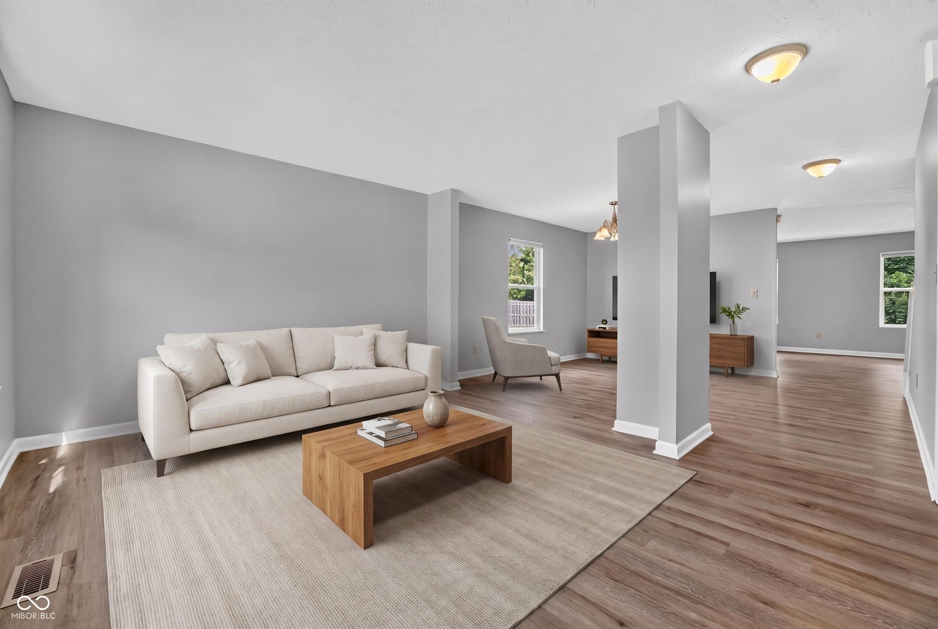 Virtually Altered - Expansive interior with wood-finish flooring, light gray walls, white trim, and recessed lighting