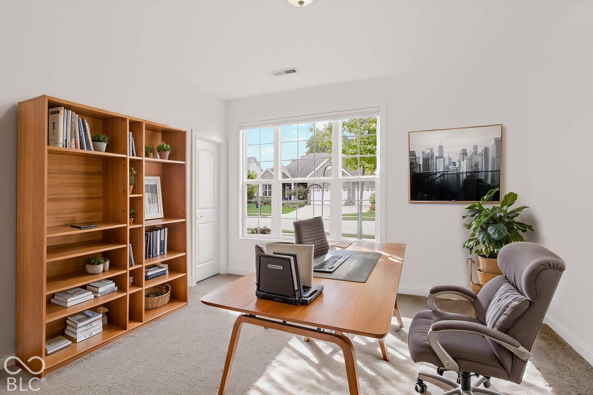 6520 Coughlan Drive, Indianapolis, IN 46278 Recessed lighting, large window with grid panes, wood-finish flooring, and a built-in shelving unit