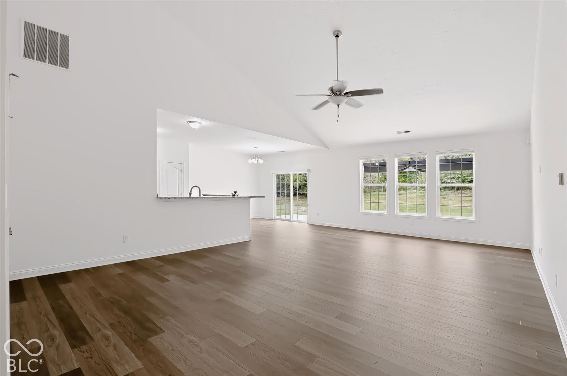 6520 Coughlan Drive, Indianapolis, IN 46278 Vaulted ceiling, wood-finish flooring, ceiling fan with light, three pane windows, and a pass-through counter with a sink