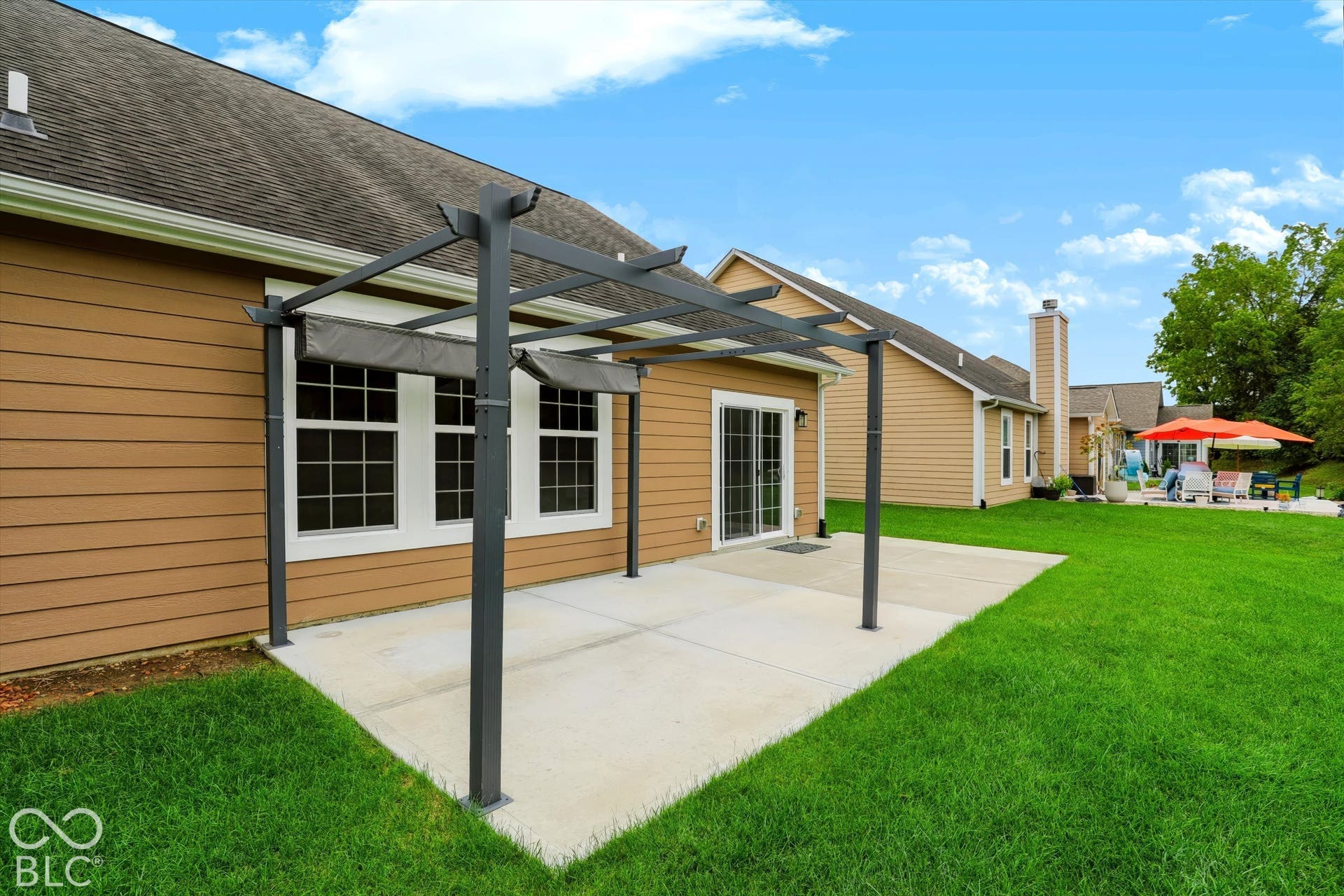 6520 Coughlan Drive, Indianapolis, IN 46278 Expansive concrete patio with a modern pergola featuring retractable shade panels