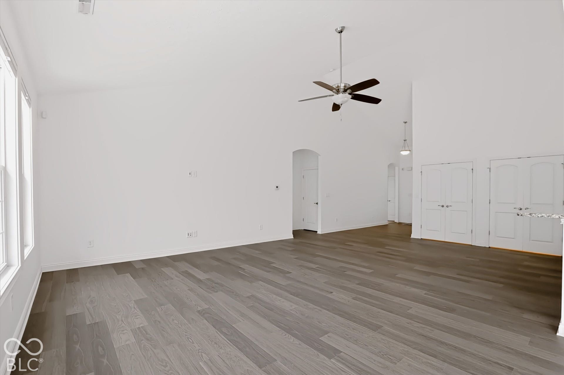 6520 Coughlan Drive, Indianapolis, IN 46278 Vaulted ceilings, wood-finish flooring, white walls, multiple windows, and a ceiling fan