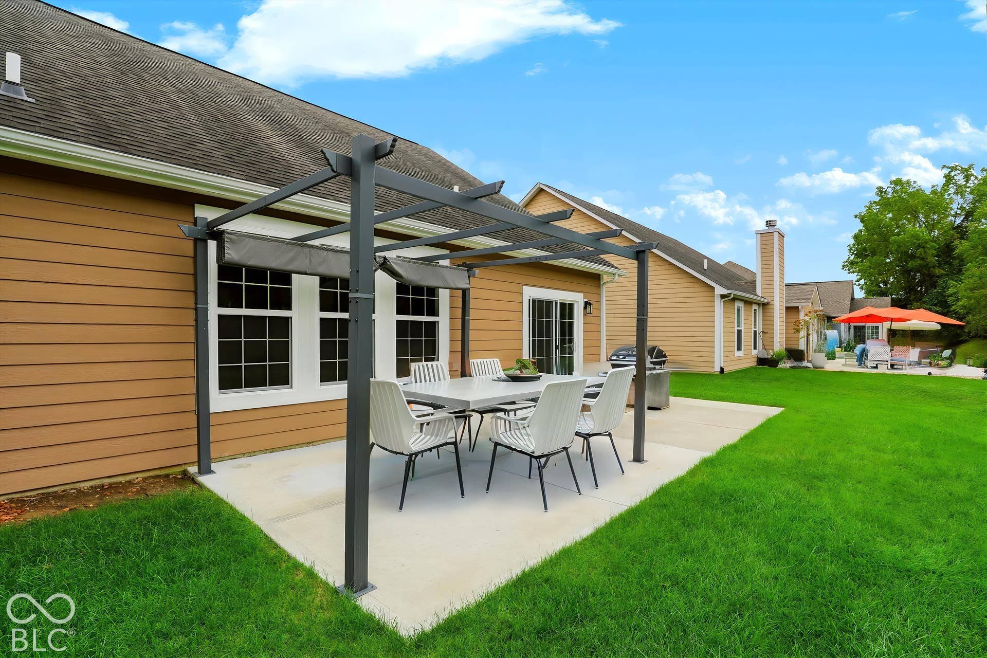 6520 Coughlan Drive, Indianapolis, IN 46278 Expansive concrete patio featuring a modern pergola with retractable canopies