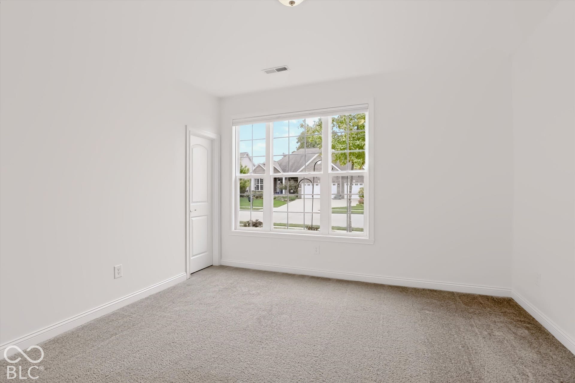 6520 Coughlan Drive, Indianapolis, IN 46278 White painted walls, gray carpeting, a multi-paned window, and a white interior door