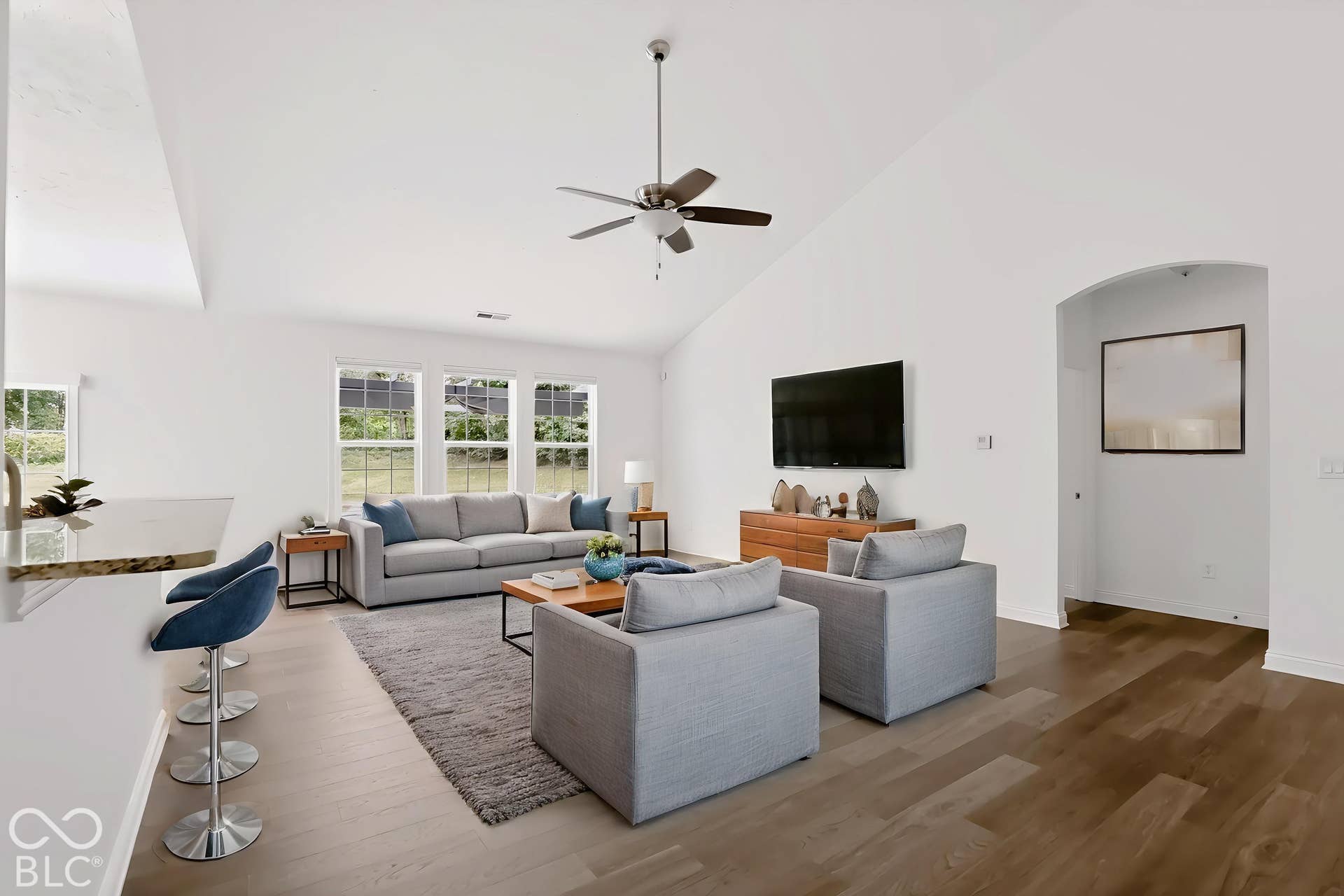 6520 Coughlan Drive, Indianapolis, IN 46278 Vaulted ceiling with a ceiling fan, wood-finish flooring, and multiple windows