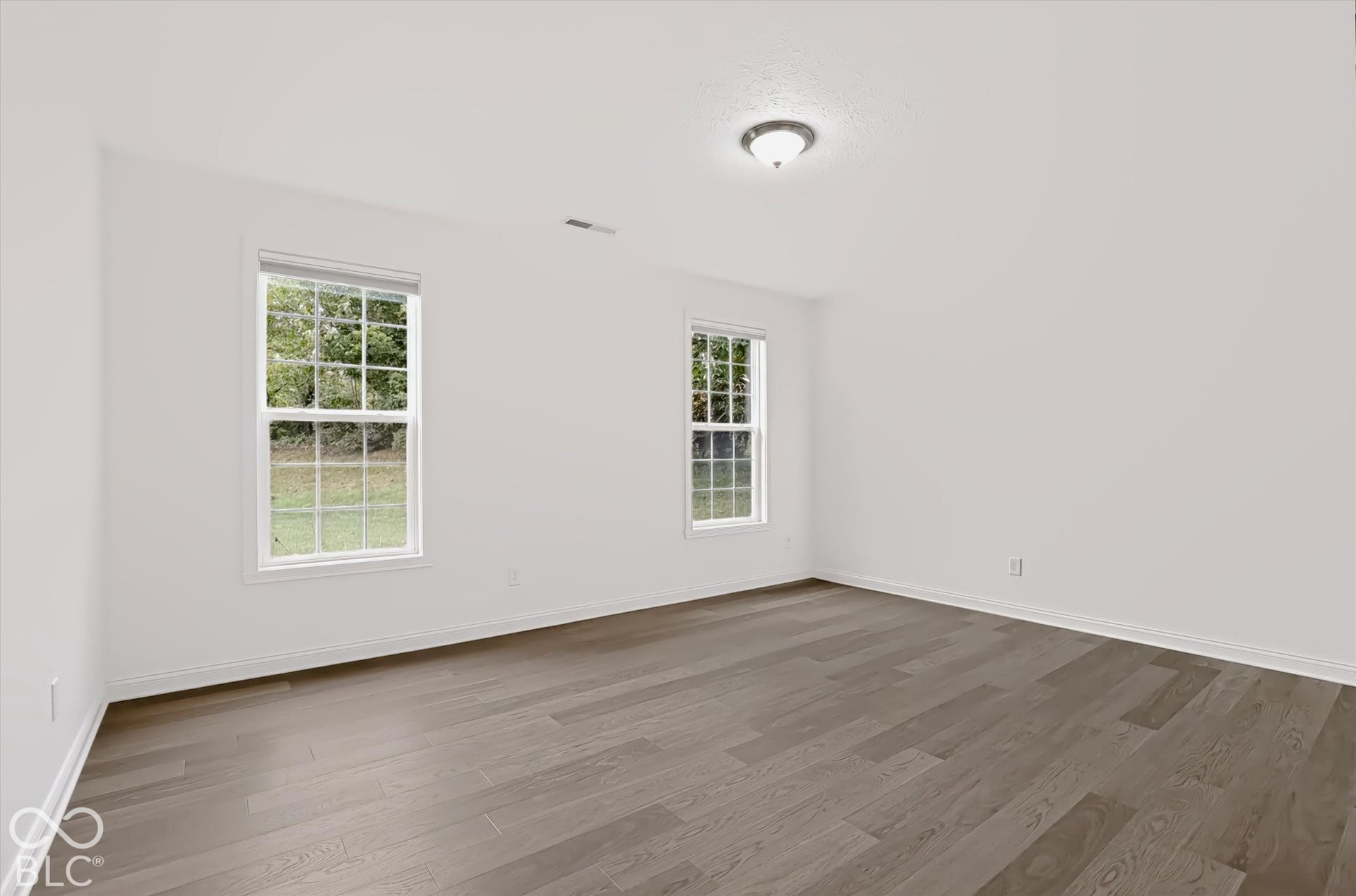 6520 Coughlan Drive, Indianapolis, IN 46278 Neutral wall color, wood-finish flooring, and a semi-flush mount ceiling light