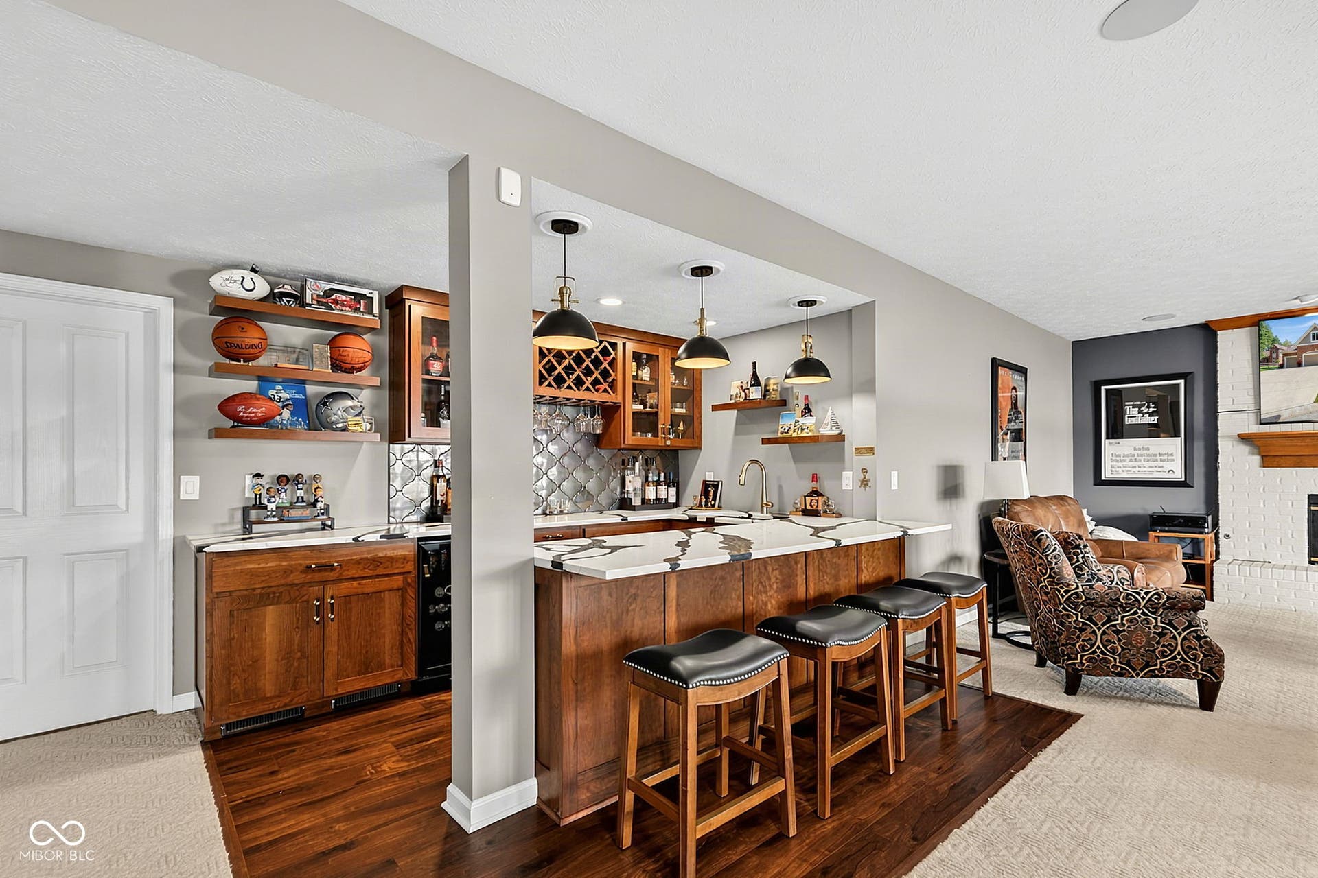 Built-in wet bar featuring beautiful custom cabinetry.