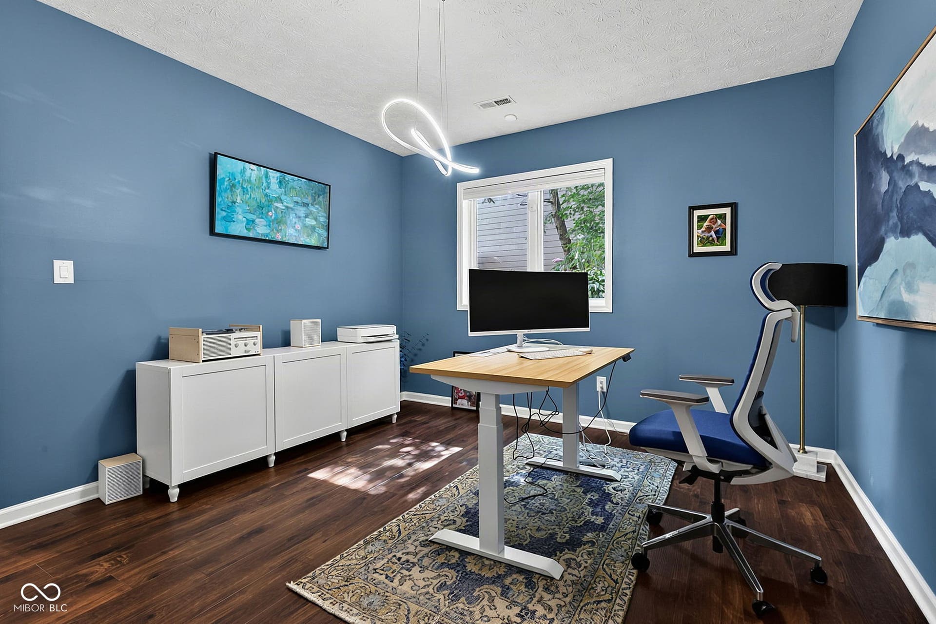 5th bedroom or office with hardwood-style flooring, white trim, and a window with natural light.