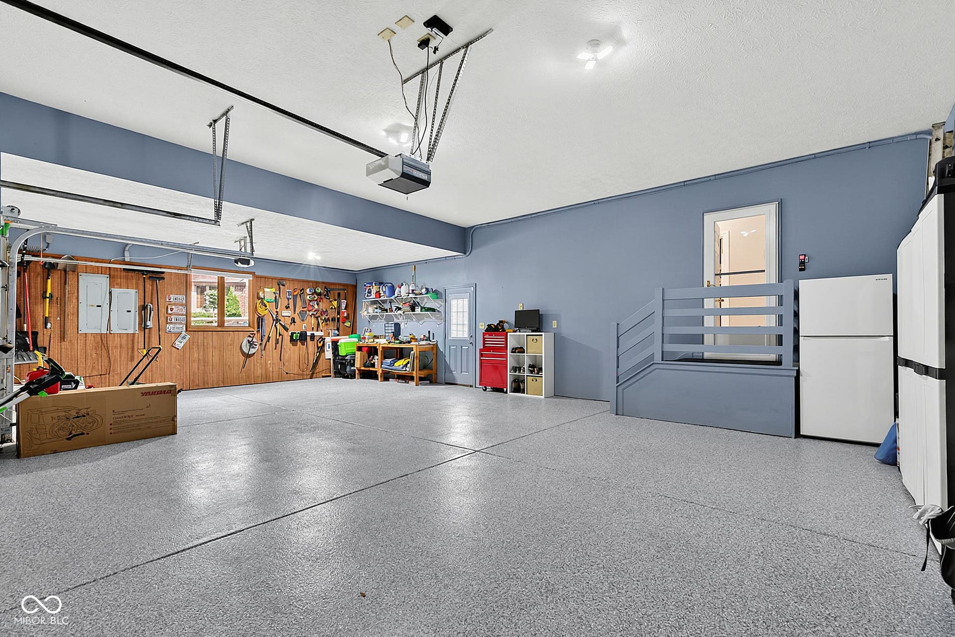 Spacious garage featuring a durable epoxy floor.