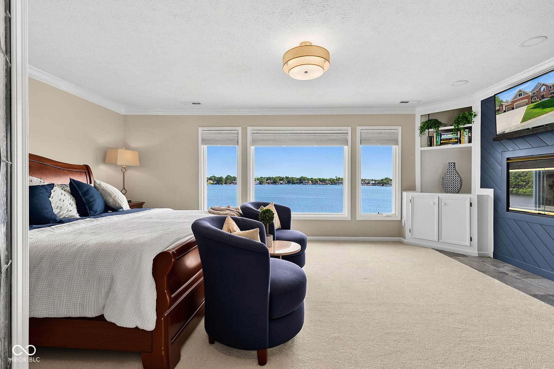 Large primary bedroom with beautiful lake views that's better in person!
