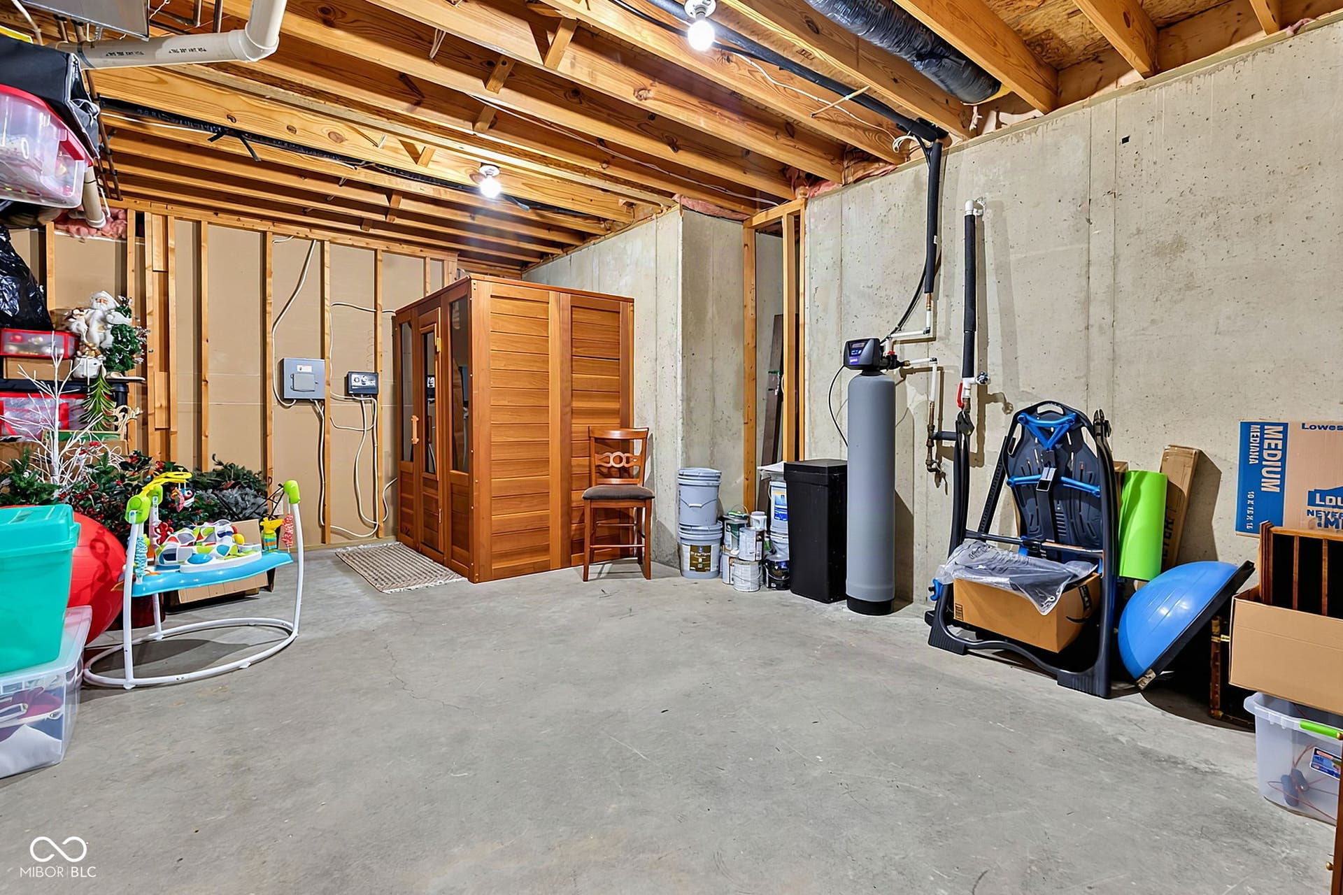 Unfinished portion of basement with plenty of storage and sauna.