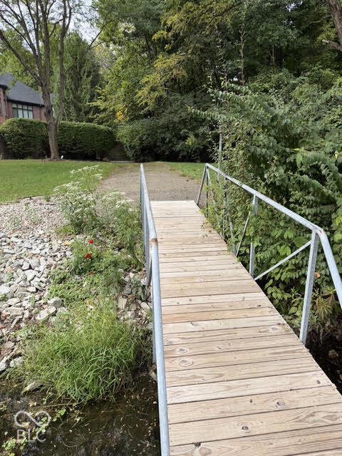 Wood plank dock with metal railings extending over water