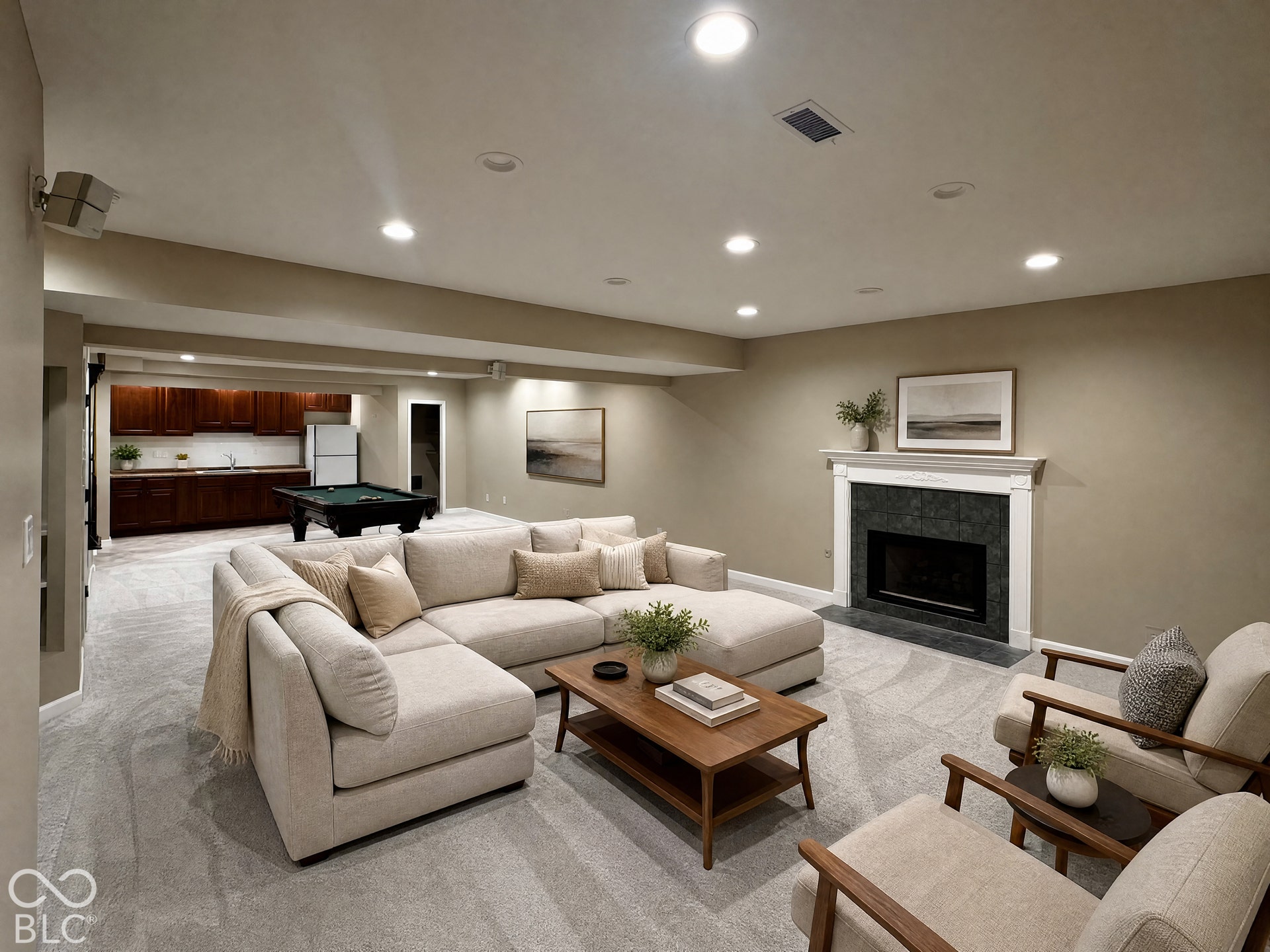 Virtually Altered - Recessed lighting, a fireplace with a white mantel and dark tile surround, a built-in wet bar with dark wood cabinetry, and light-toned carpeting throughout
