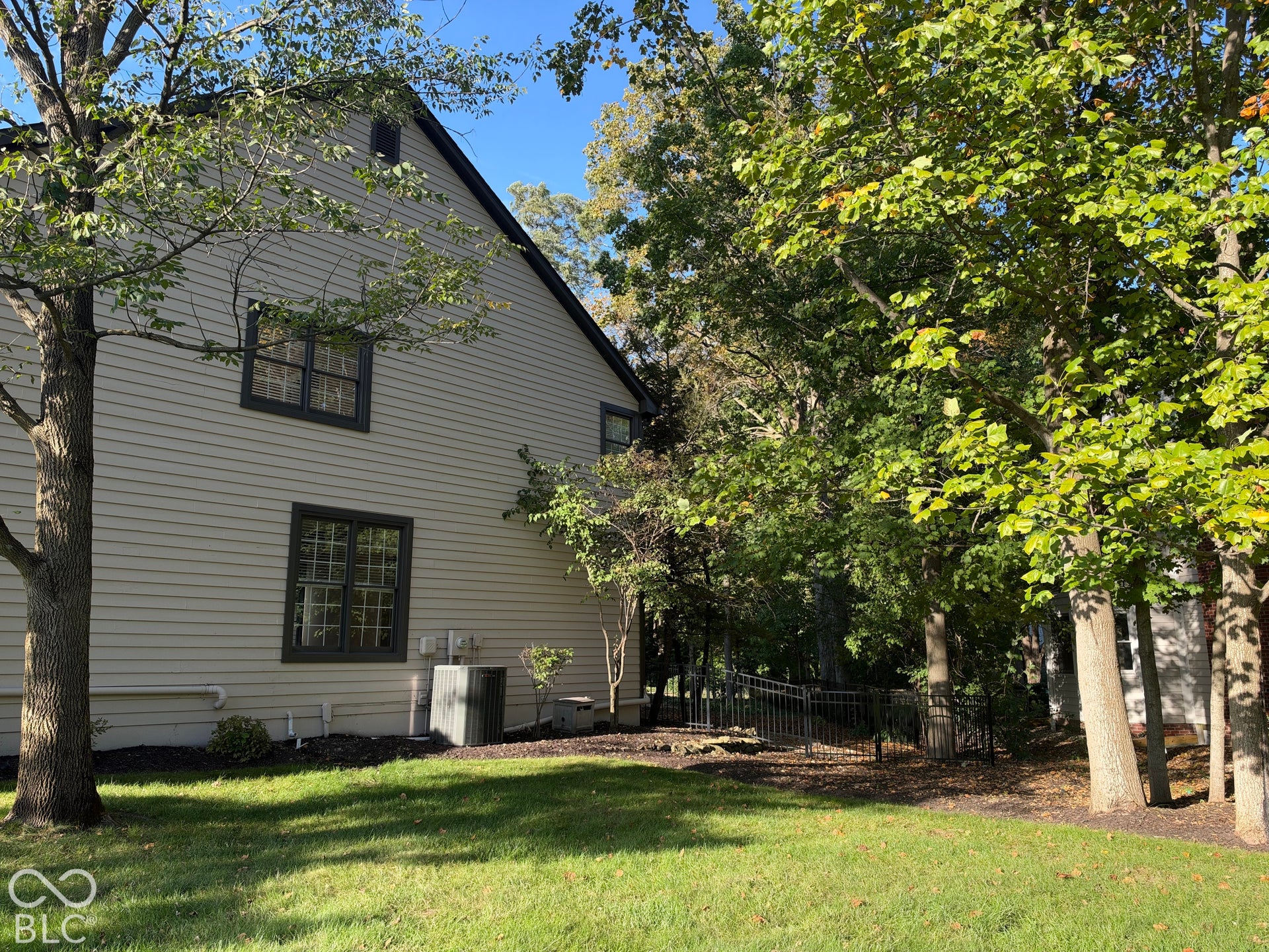 Light-colored horizontal siding with dark trim windows