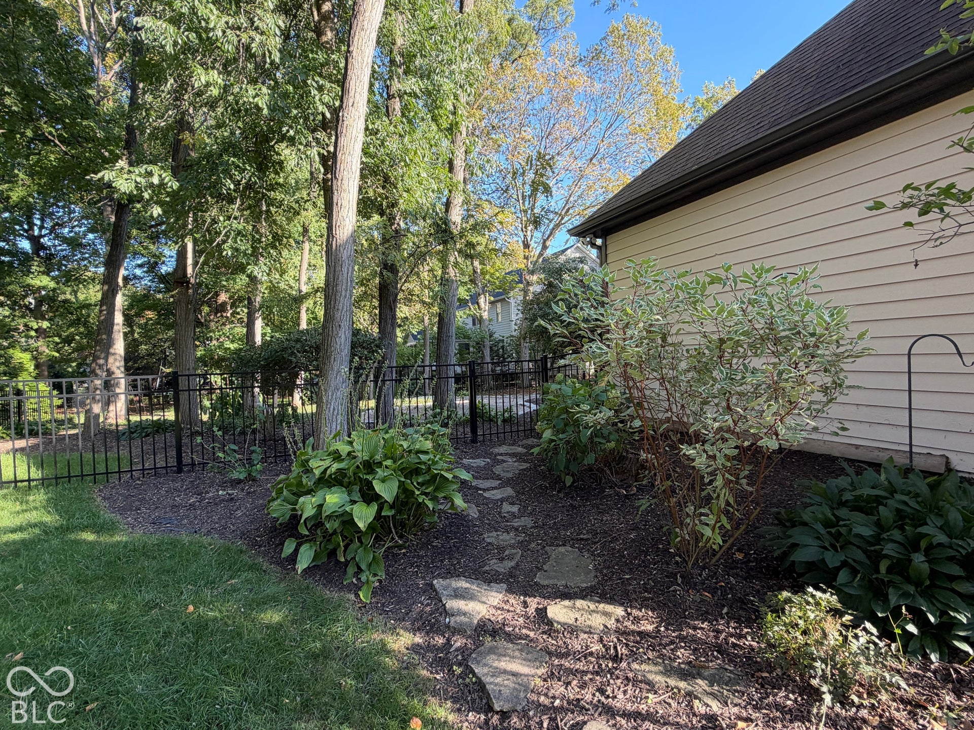 Siding exterior with a dark shingle roof and coordinating gutters