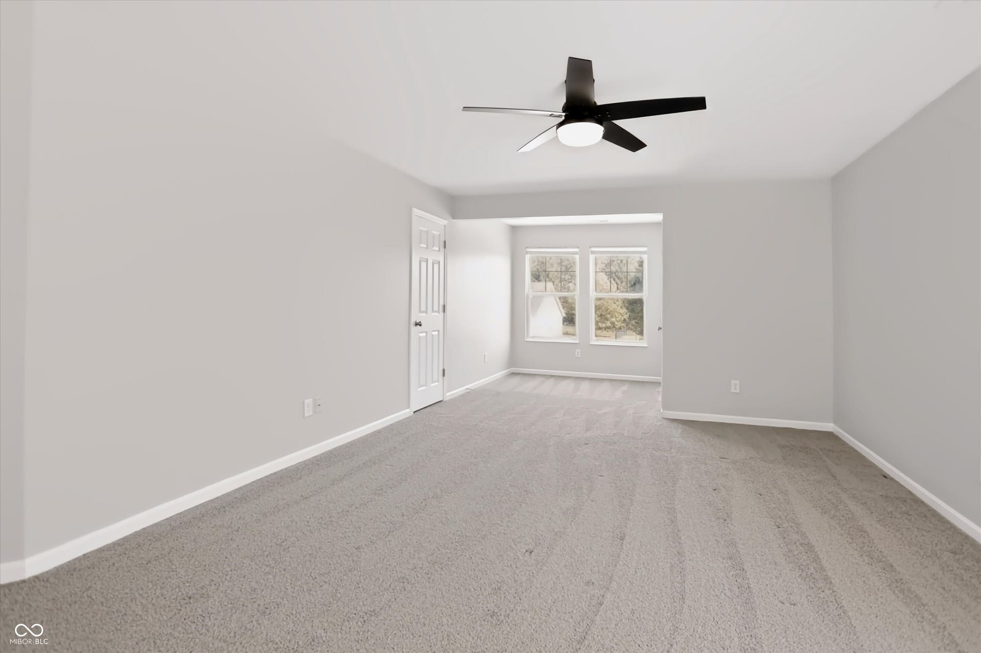 2536 Autumn Road, Indianapolis, IN 46229 Spacious room featuring neutral paint, gray carpeting, a ceiling fan with integrated lighting, and multiple windows