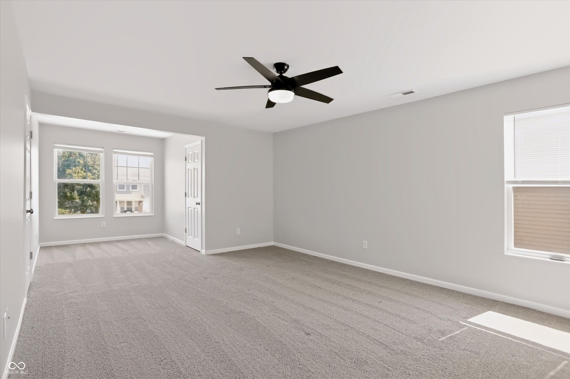 2536 Autumn Road, Indianapolis, IN 46229 Carpeted room featuring a ceiling fan, multiple windows, and light gray wall finishes