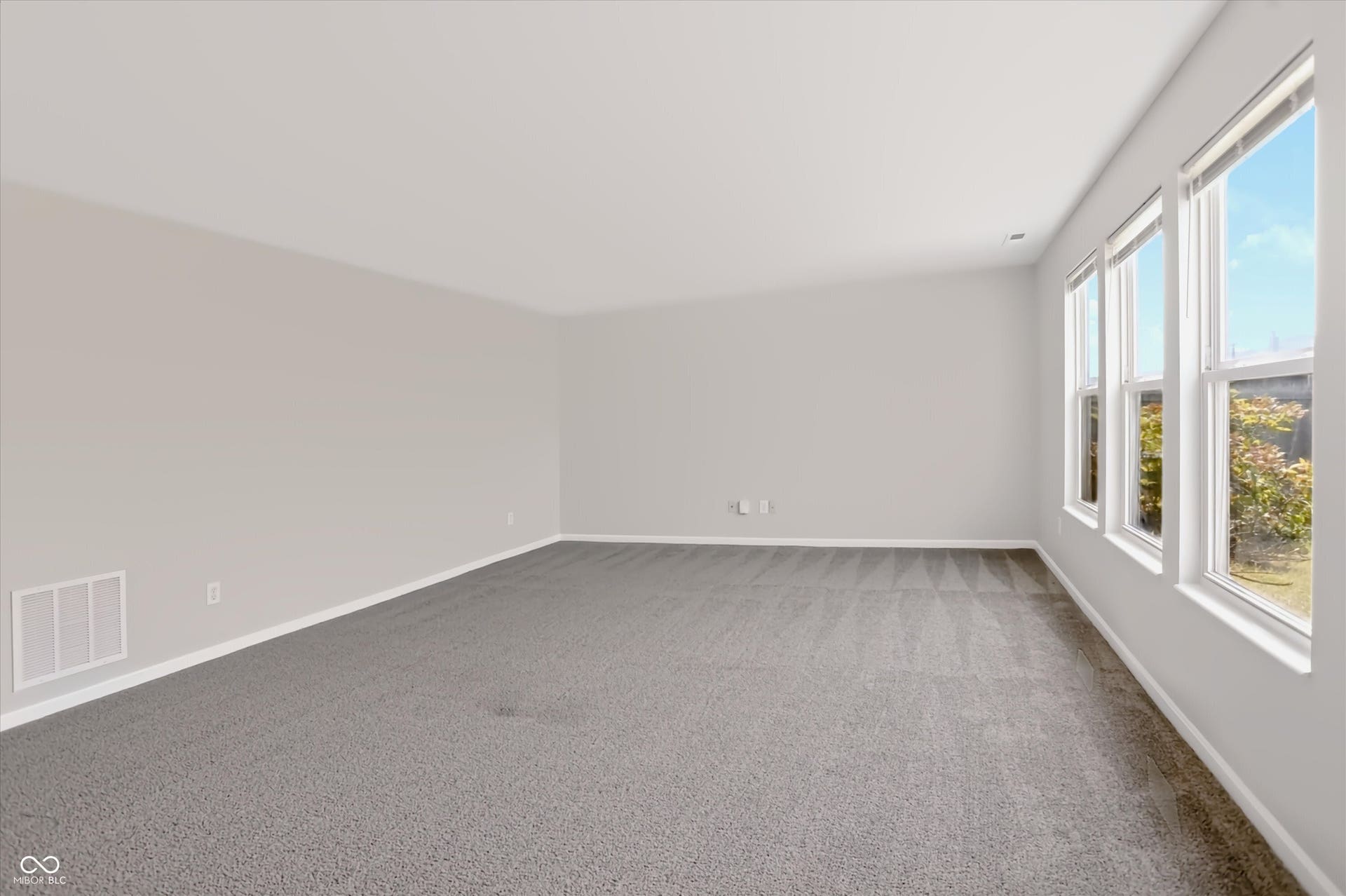 2536 Autumn Road, Indianapolis, IN 46229 Neutral paint palette, gray carpeting, and three large windows