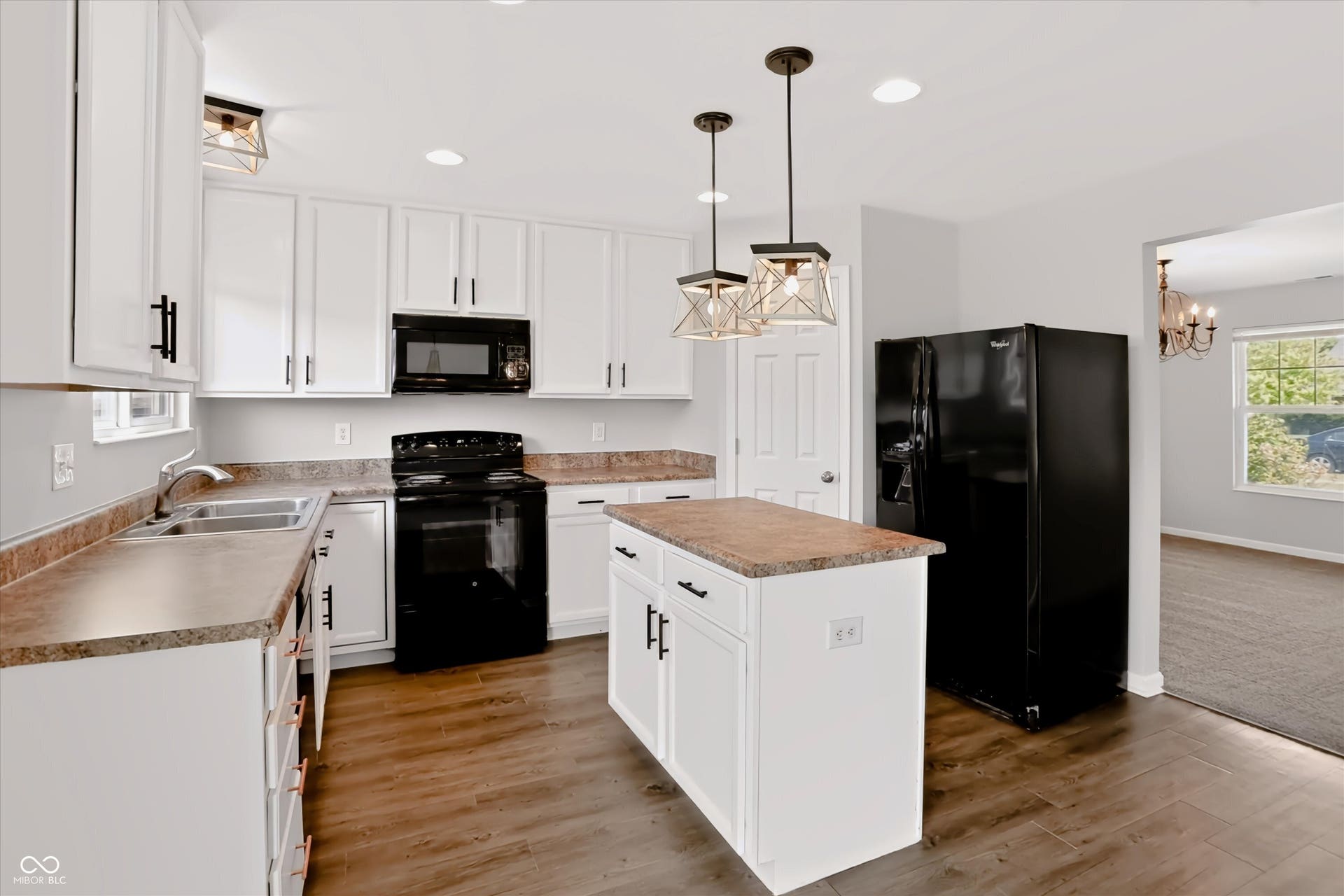 2536 Autumn Road, Indianapolis, IN 46229 White cabinetry with black hardware, wood-finish flooring, recessed lighting, kitchen island, and stainless steel sink