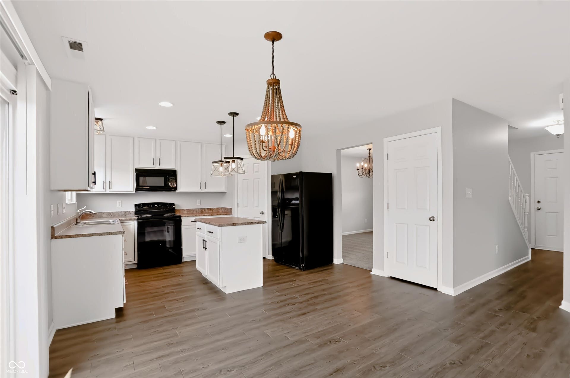 2536 Autumn Road, Indianapolis, IN 46229 Kitchen featuring white cabinetry, dark wood-finish flooring, a central island, and black appliances