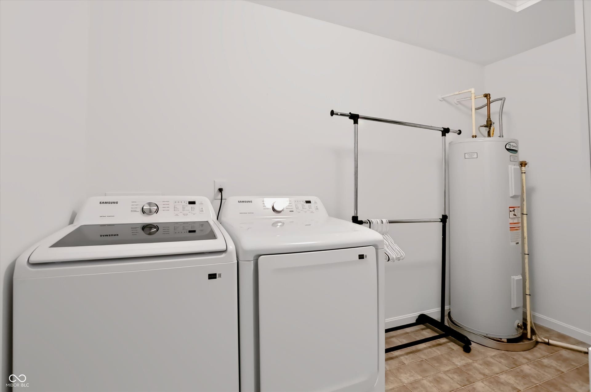 2536 Autumn Road, Indianapolis, IN 46229 Laundry area with tiled flooring, white walls, and a visible water heater