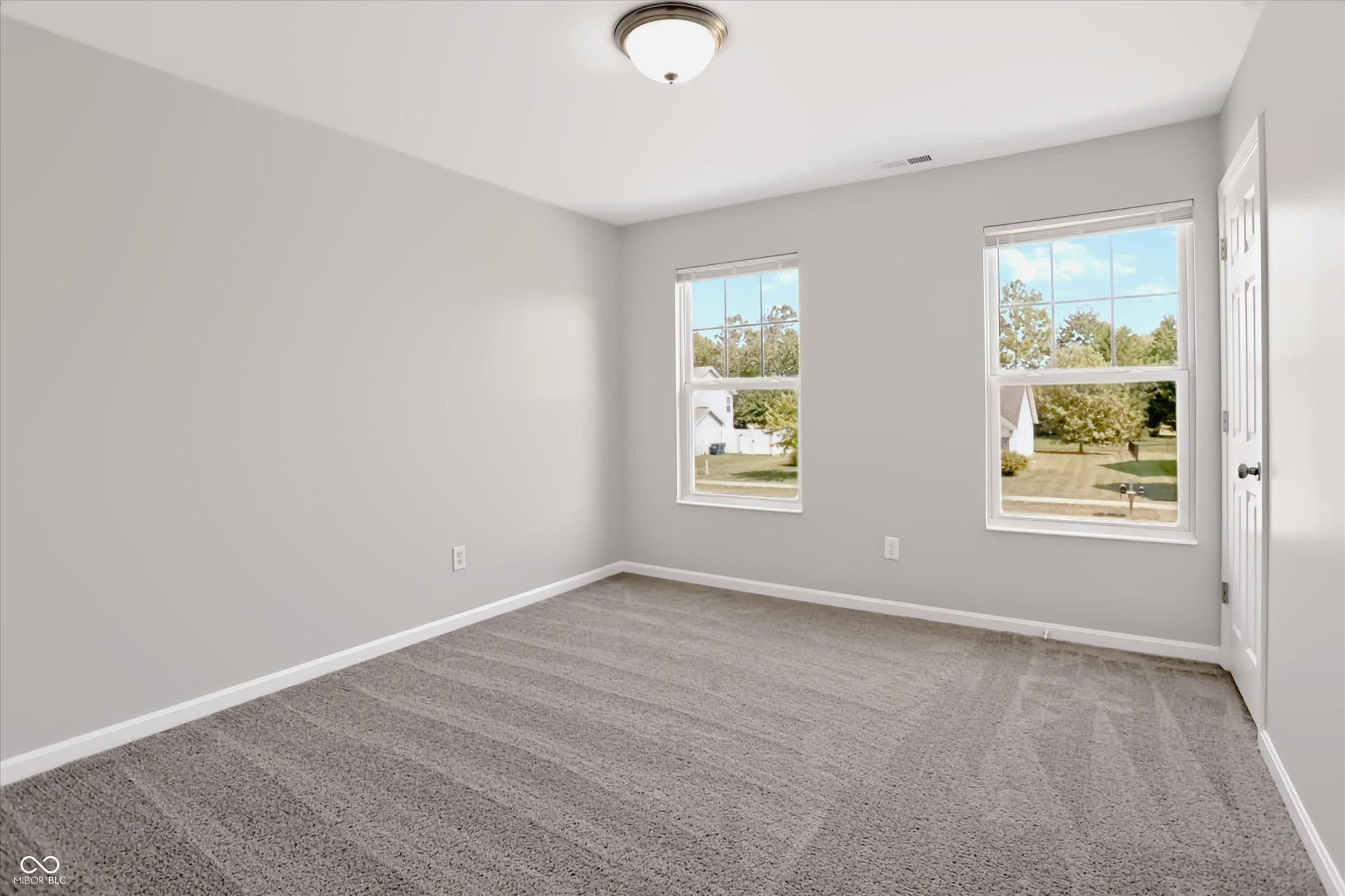 2536 Autumn Road, Indianapolis, IN 46229 Neutral wall paint, plush carpet flooring, two sash windows, and ceiling-mounted lighting