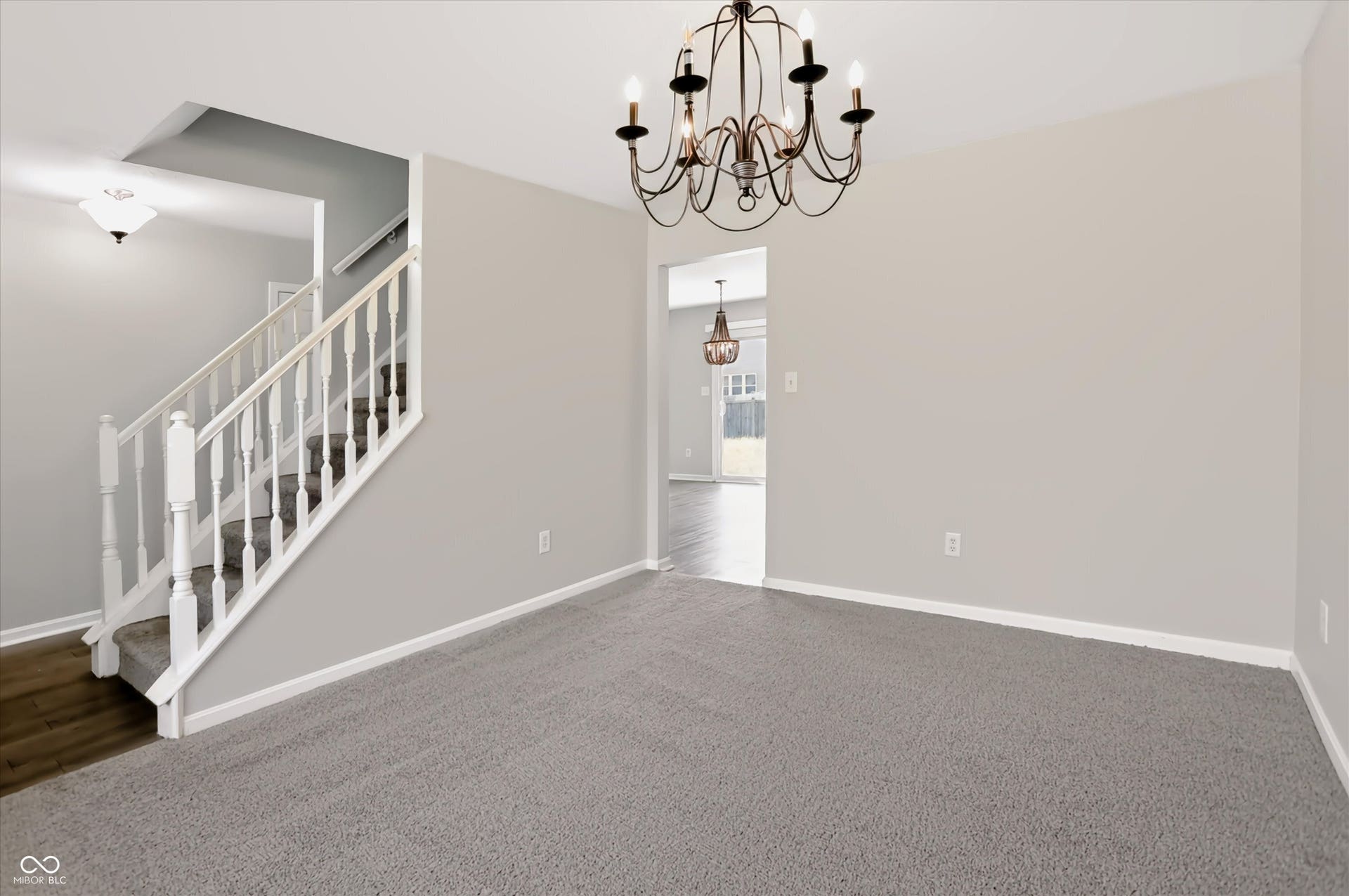 2536 Autumn Road, Indianapolis, IN 46229 Carpeted flooring, white trim, and a decorative chandelier