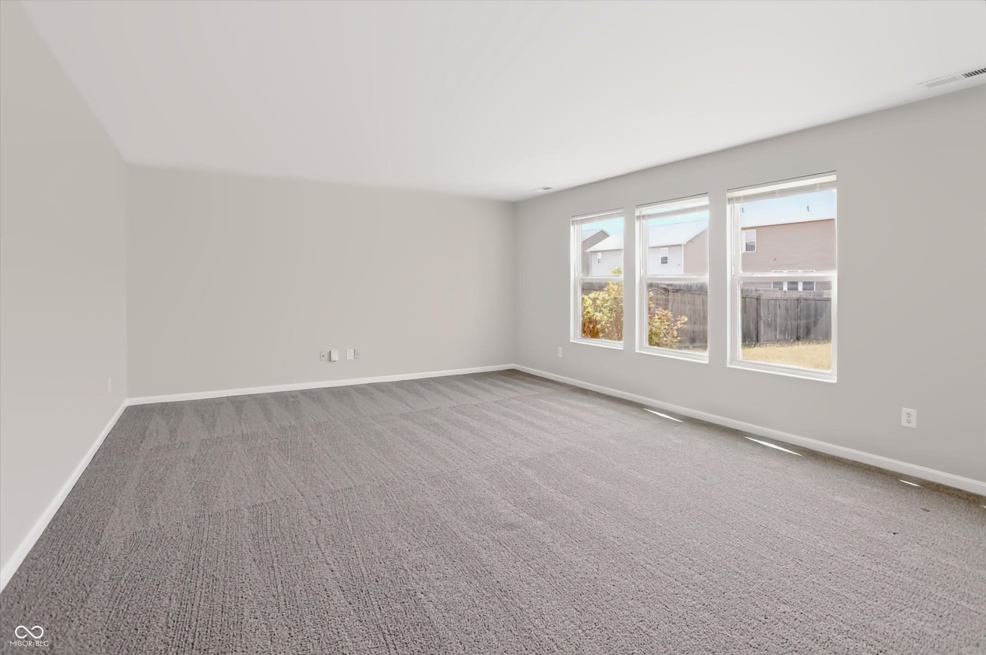 2536 Autumn Road, Indianapolis, IN 46229 Spacious room with gray textured carpeting, white walls, and multiple large windows