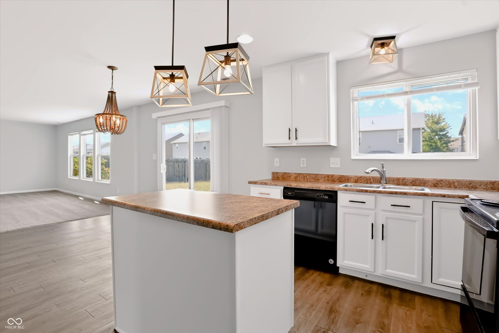 2536 Autumn Road, Indianapolis, IN 46229 Kitchen island with countertop, wood-finish flooring, white cabinetry, and stainless steel sink