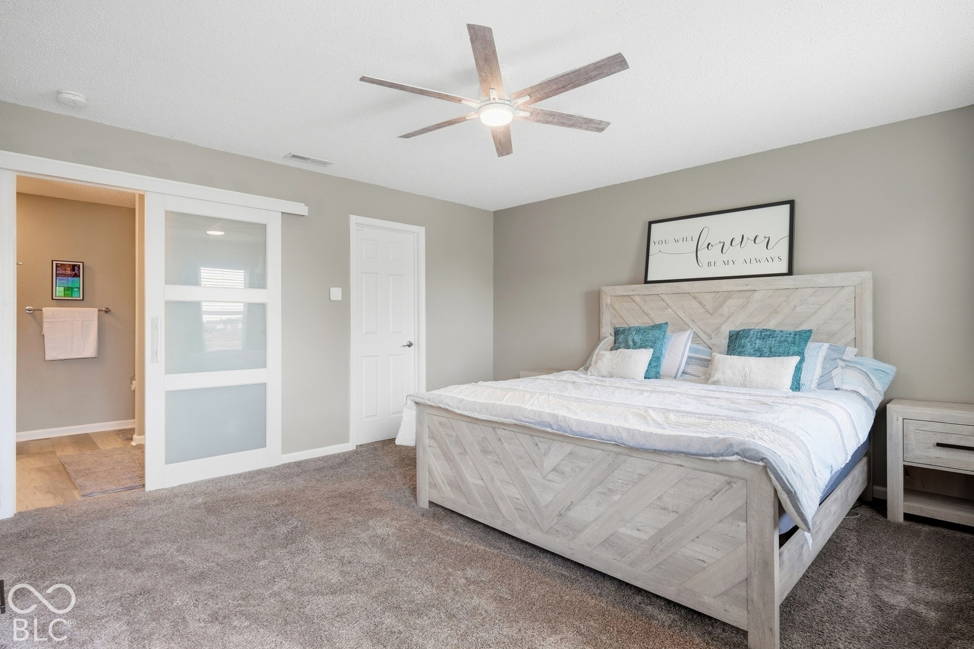 Recessed ceiling fan with integrated lighting, soft gray wall paint, and gray carpeting
