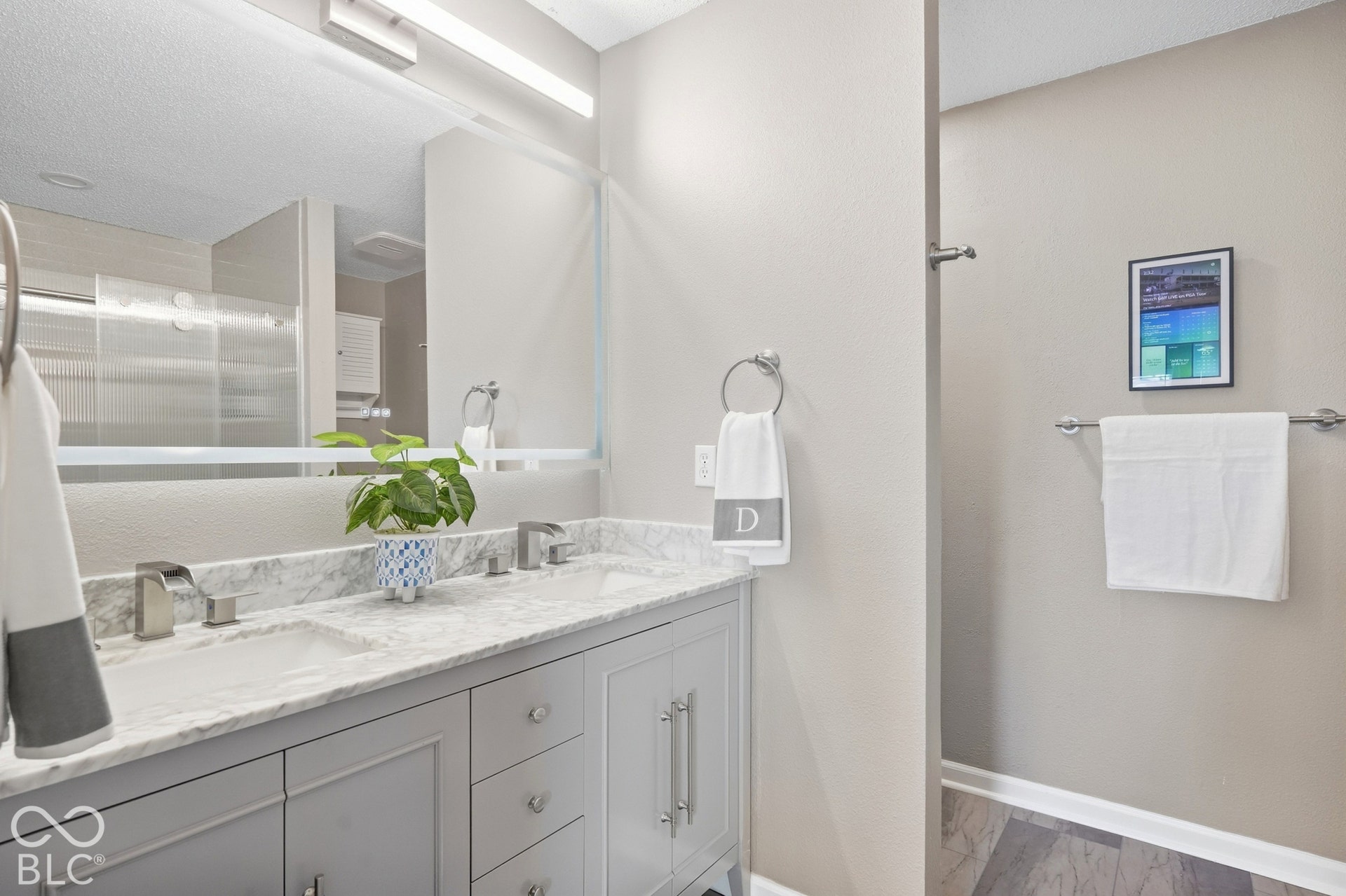 Dual vanity with undermount sinks, gray cabinetry, and a light-toned countertop