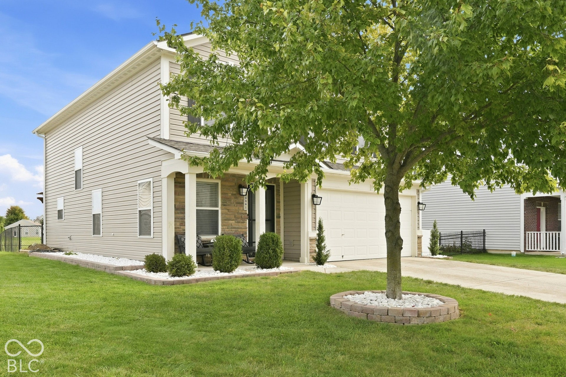 Two-story residence featuring siding and stone accents