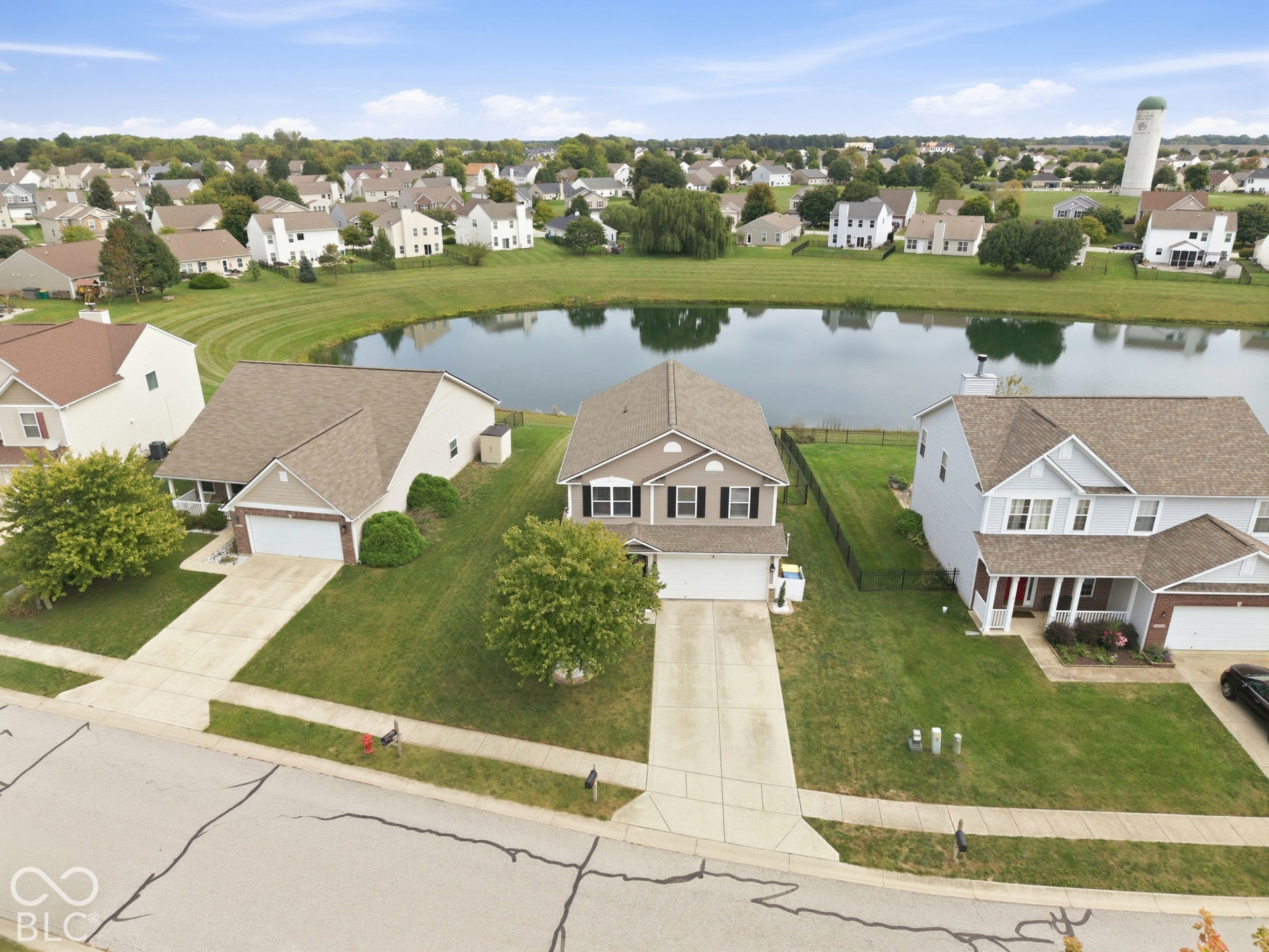 Established residential neighborhood featuring a pond and surrounding green space