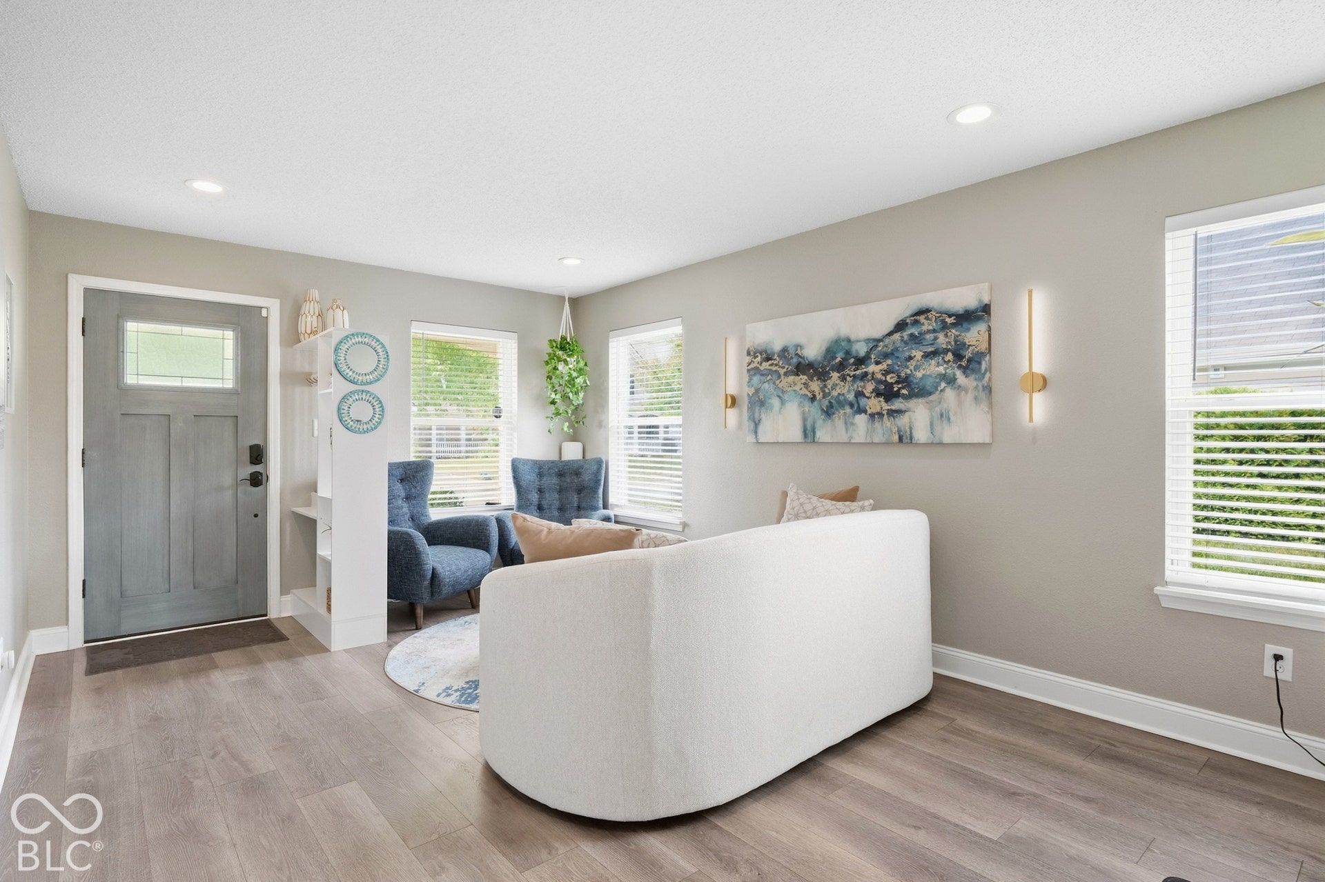 Wood-finish flooring throughout, recessed lighting, and ample natural light from multiple windows with blinds