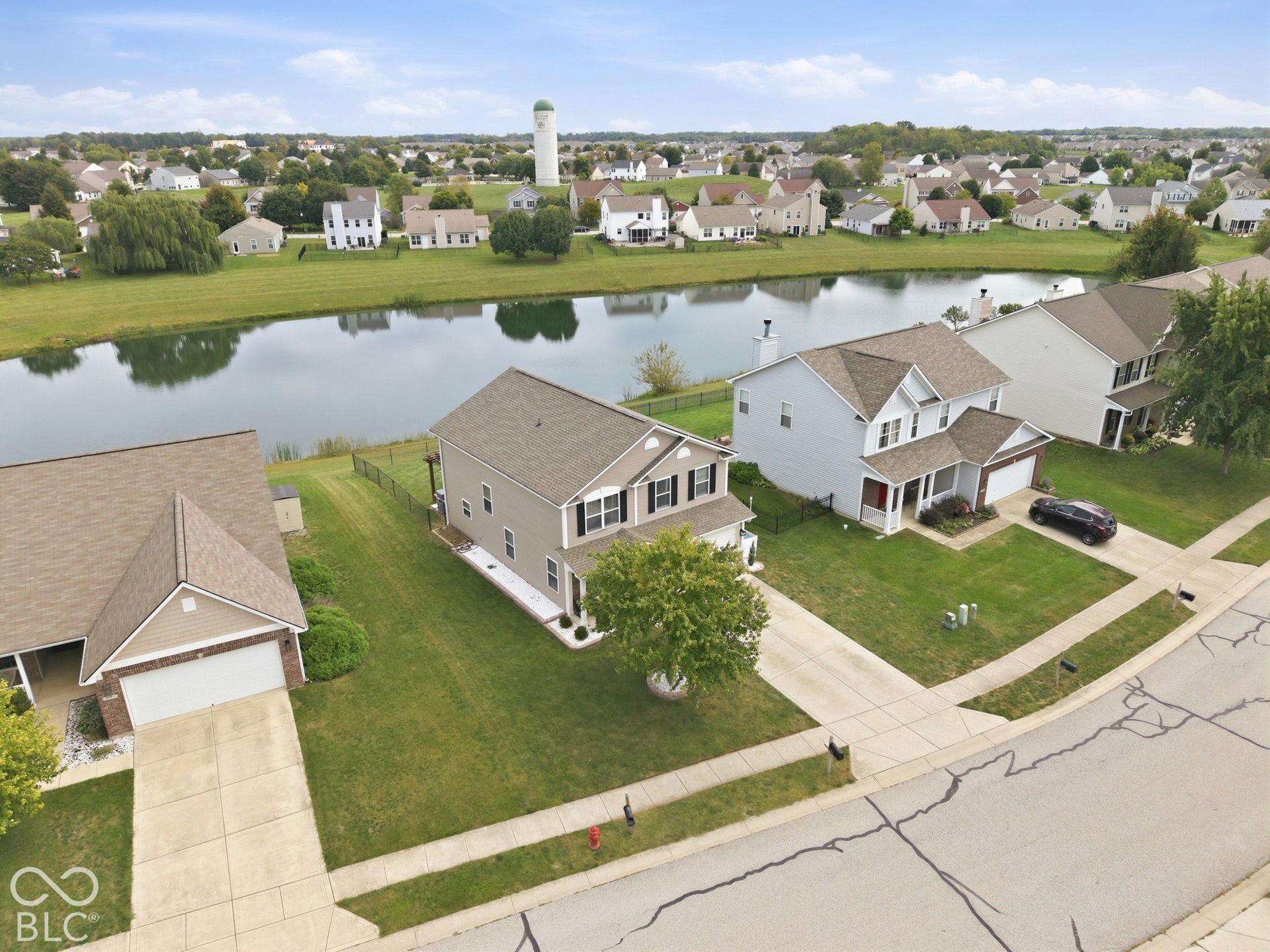 Two-story residence with a two-car garage, front porch, and a well-maintained lawn