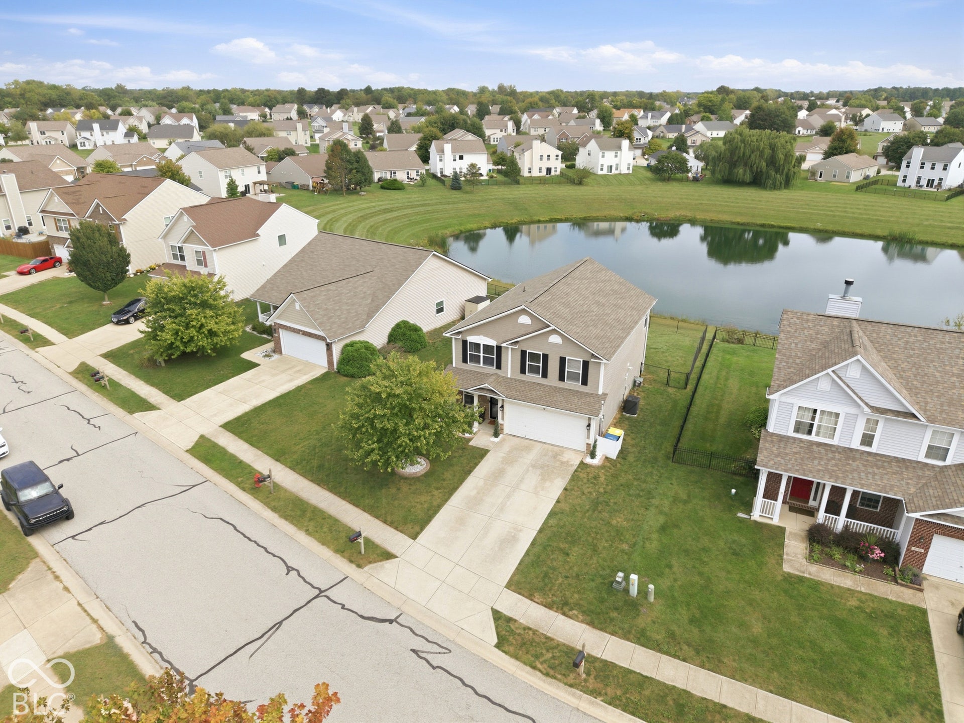 Residential property with a landscaped front yard, attached two-car garage, and paved driveway