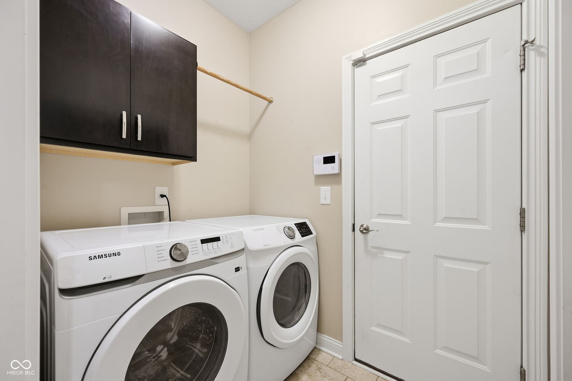 2743 Rylee Court, Greenwood, IN 46143 Built-in overhead cabinetry with brushed nickel hardware, light-toned wall paint, and tile flooring