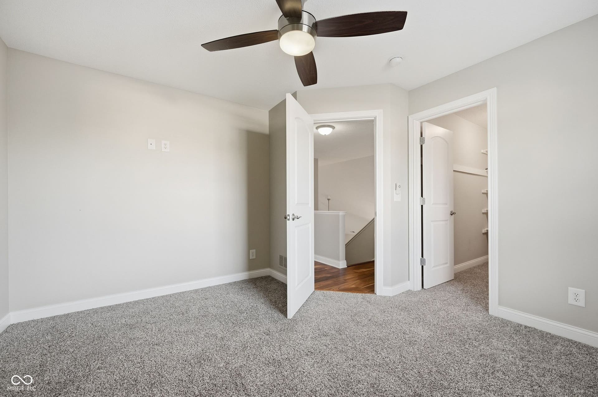 2743 Rylee Court, Greenwood, IN 46143 Textured gray carpeting, ceiling fan with wood-finish blades, white trim, and white interior doors
