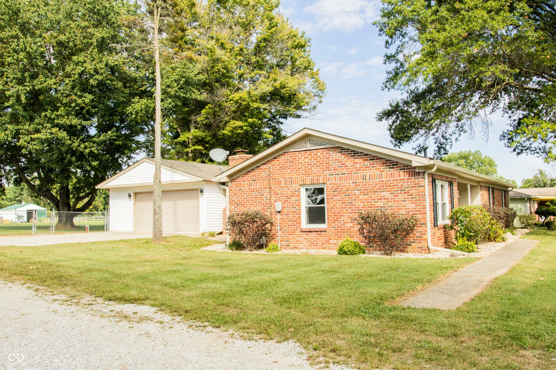 Brick exterior with white window trim and dark shutters