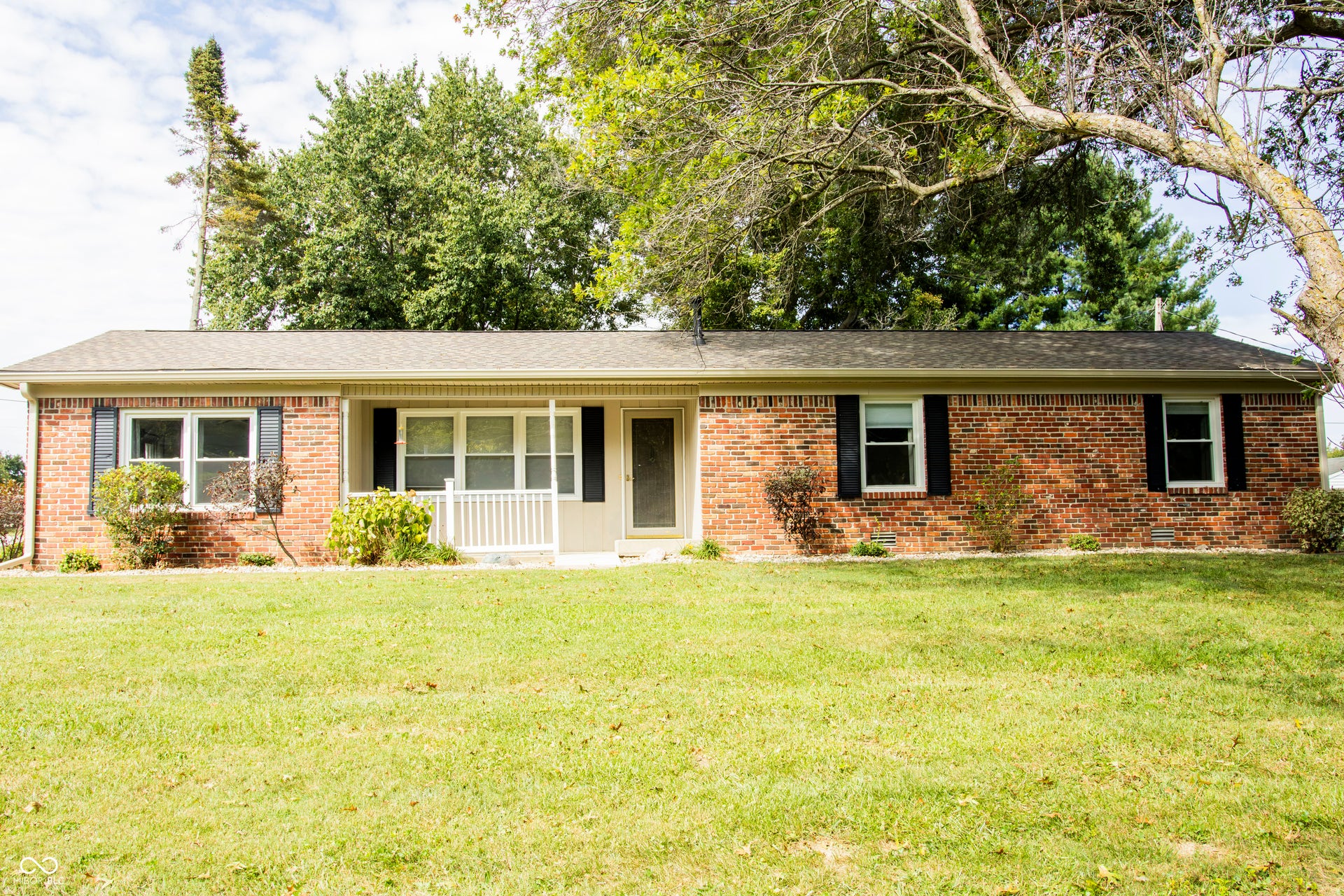 Brick exterior with a gabled roof and black shutters