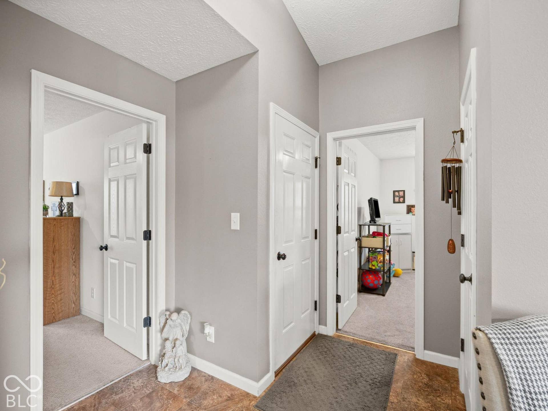 Across from the full bath are the entrances to bedroom 2 & 3, plus door to garage