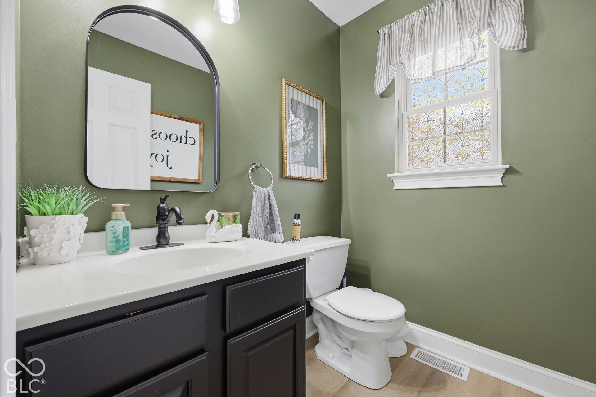 The main-level half bath sits just off the living room, conveniently located for guest and everyday use.