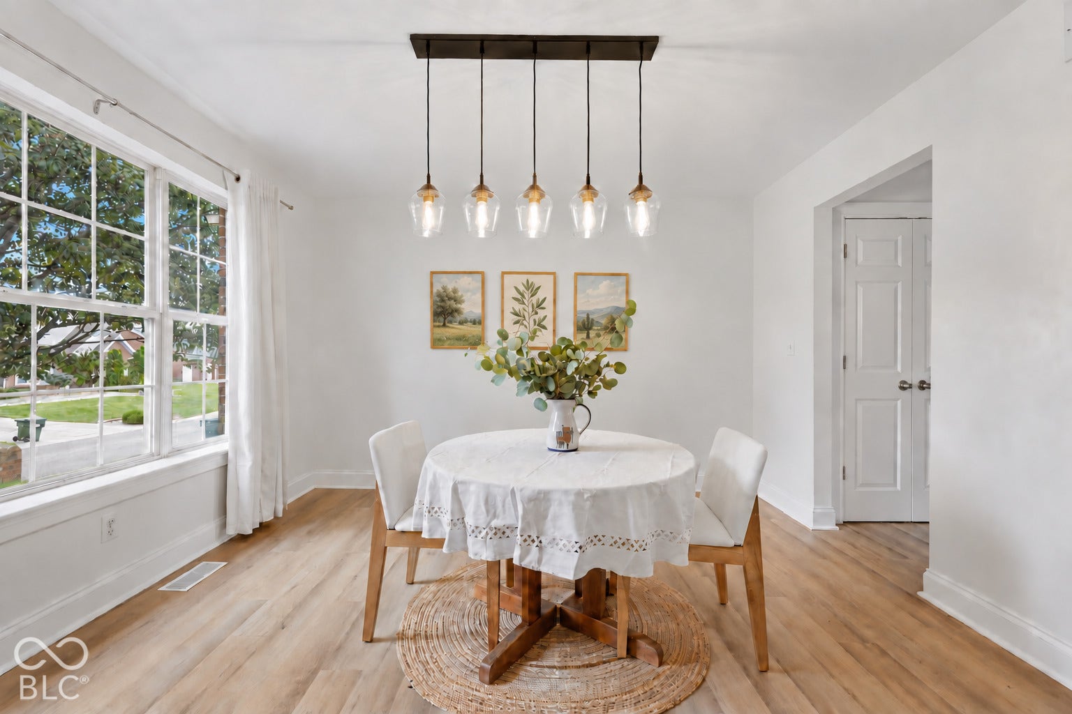 12x12 formal dining room sits just off the kitchen and features new hardwood flooring, new light fixture, and a large picture window that fills the space with natural light.