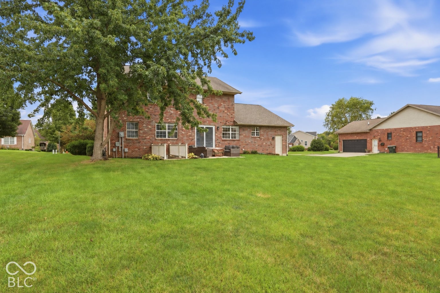 The backyard is another reason to love this home. There's plenty of lawn to enjoy, shade from the mature tree, and a patio that makes it easy to spend more time outside.