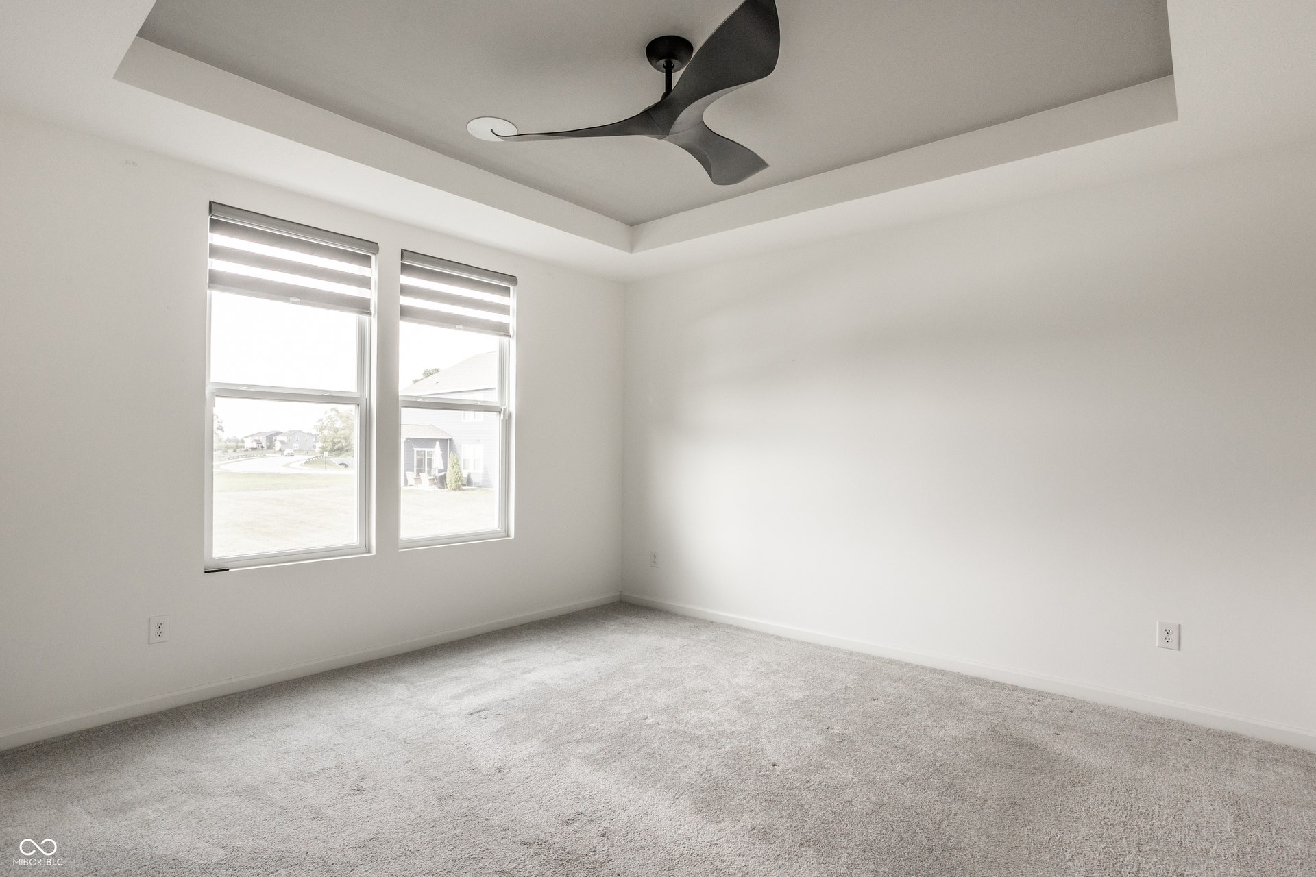 Master on the Main with tray ceiling and ceiling fan